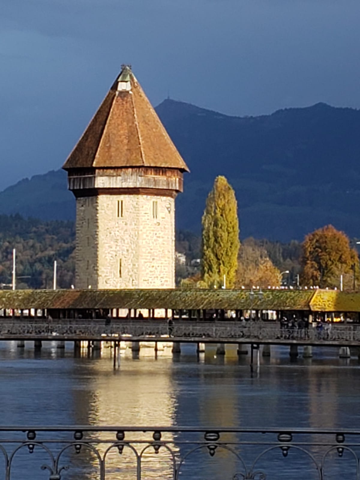 A bridge over a body of water with a tower in the background