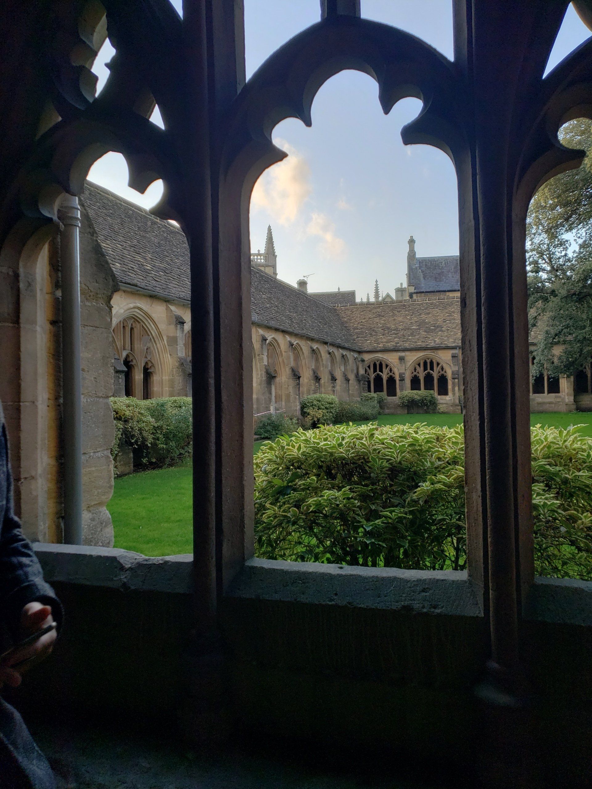 A person is looking out of a window at a church.