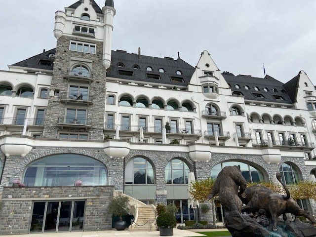 A large building with a statue in front of it
