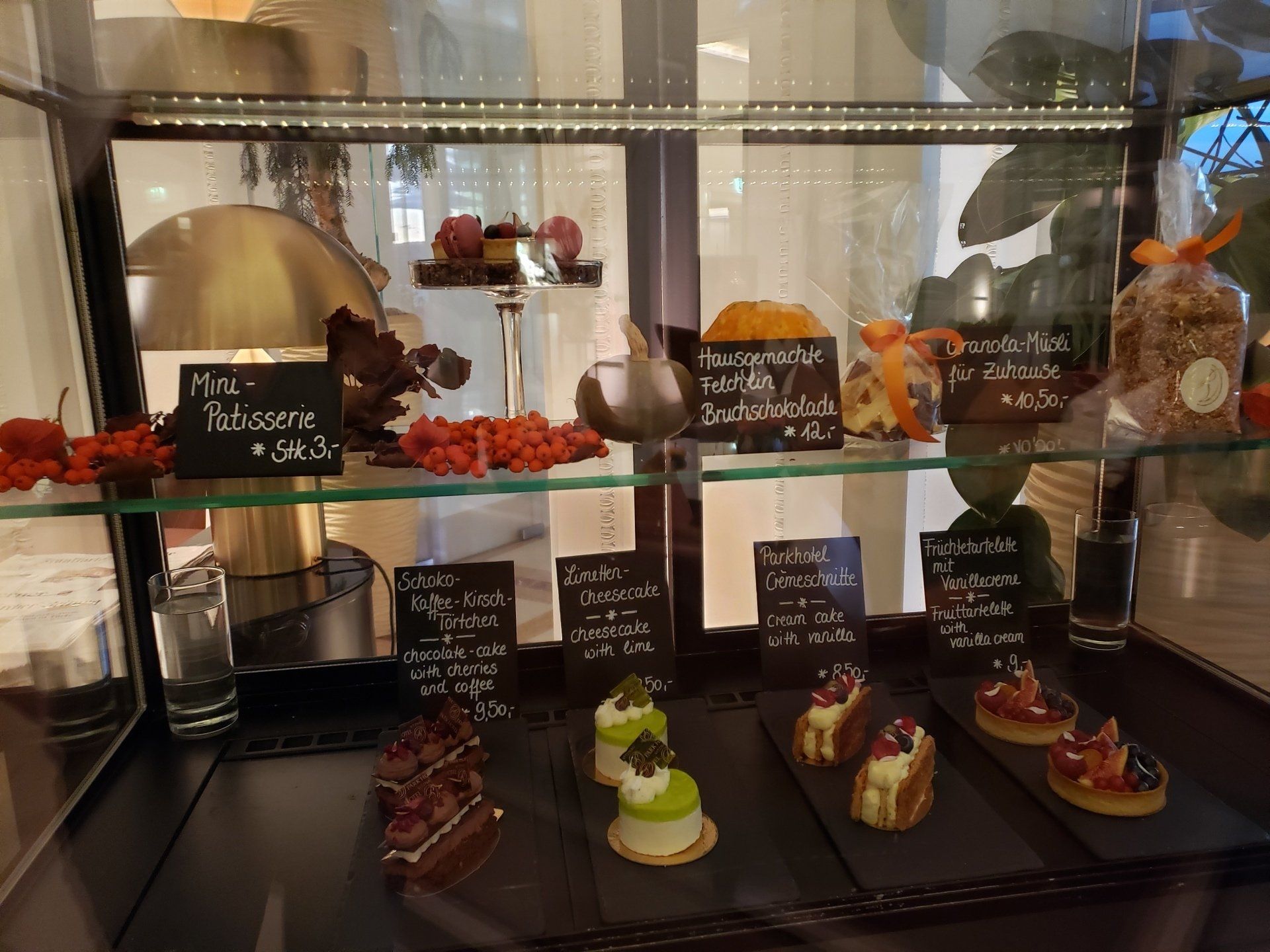 A display case with a variety of desserts in it