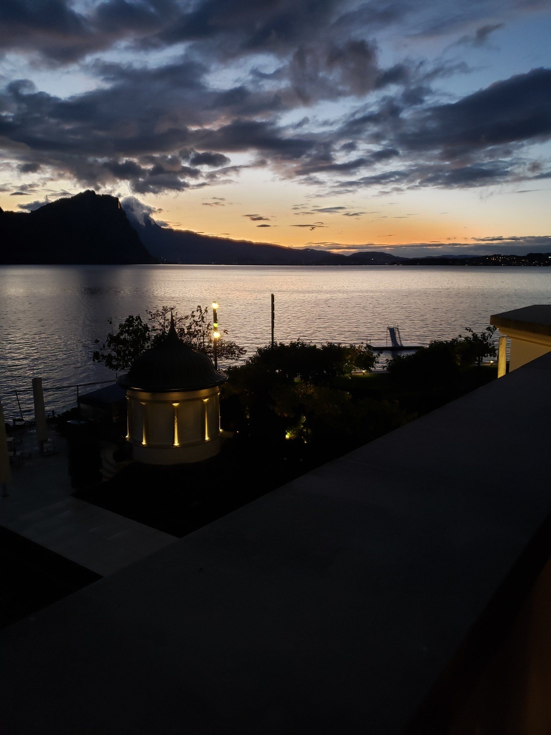 A view of a lake at sunset with mountains in the background