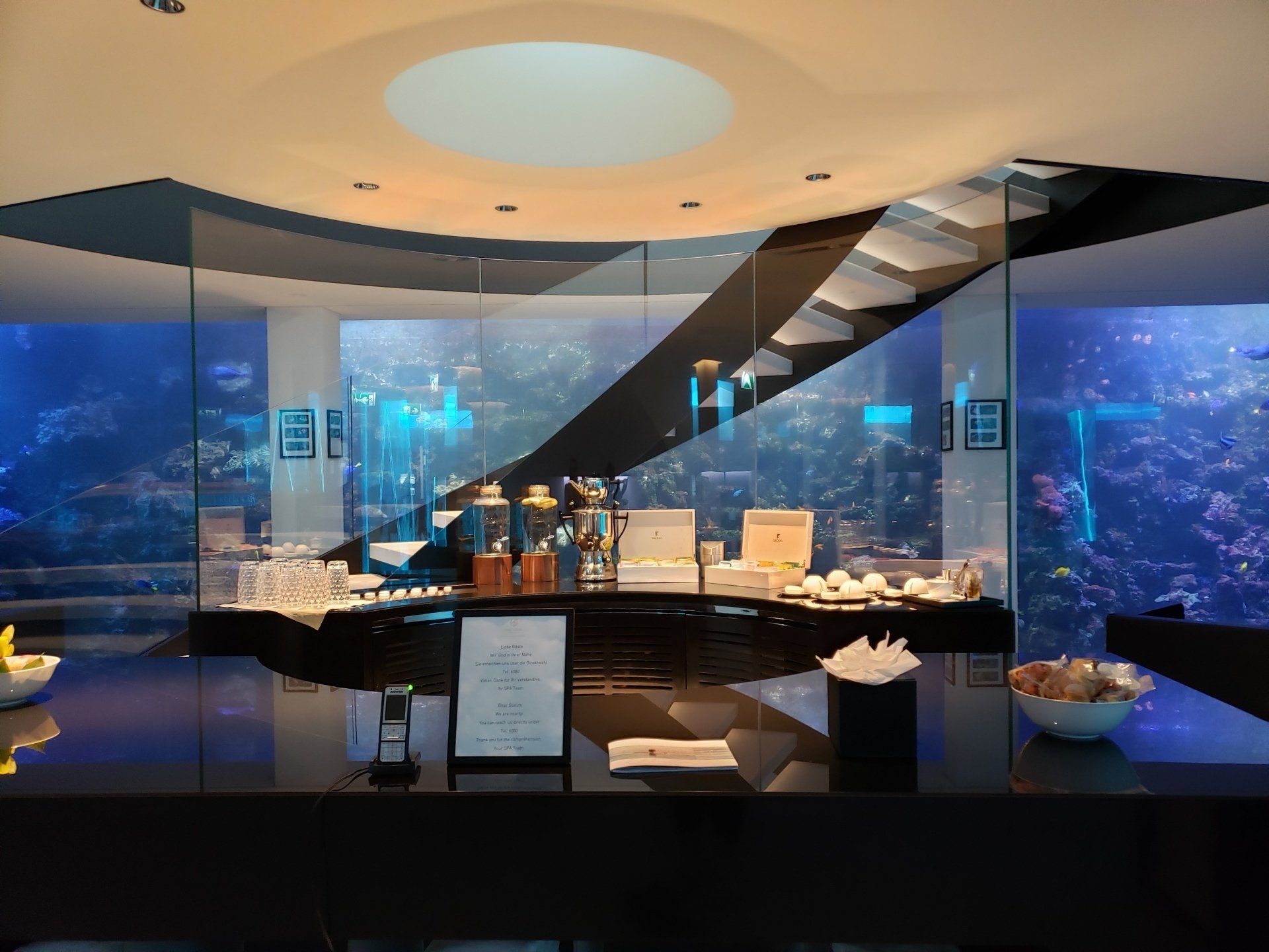 A restaurant with a large aquarium in the background