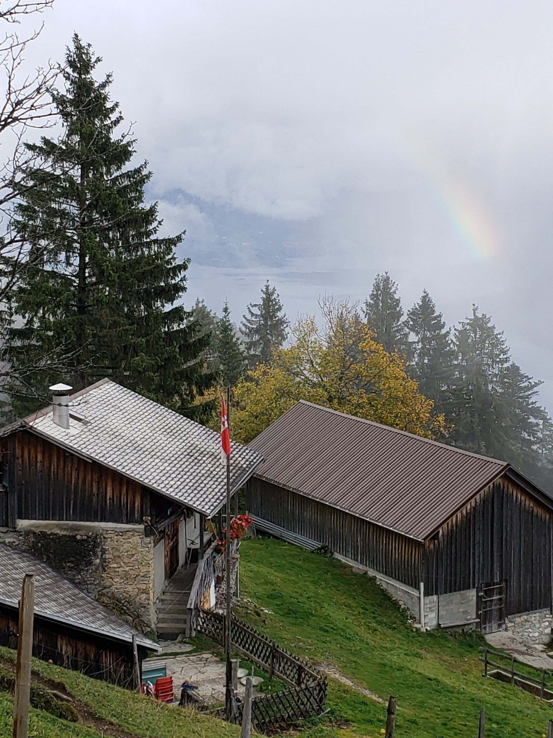 There is a rainbow in the sky above the houses.
