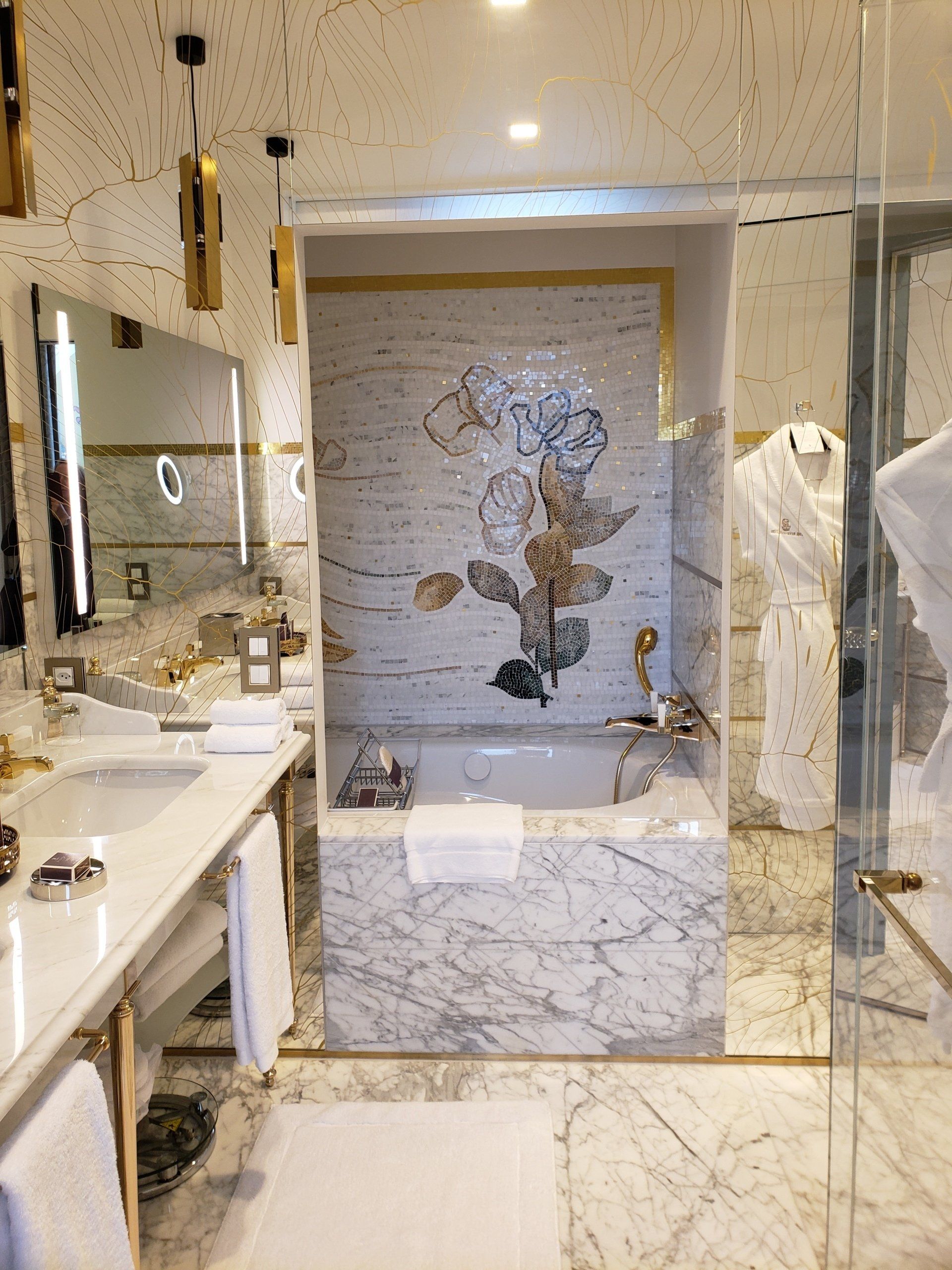 A bathroom with a bathtub , sink and mirror