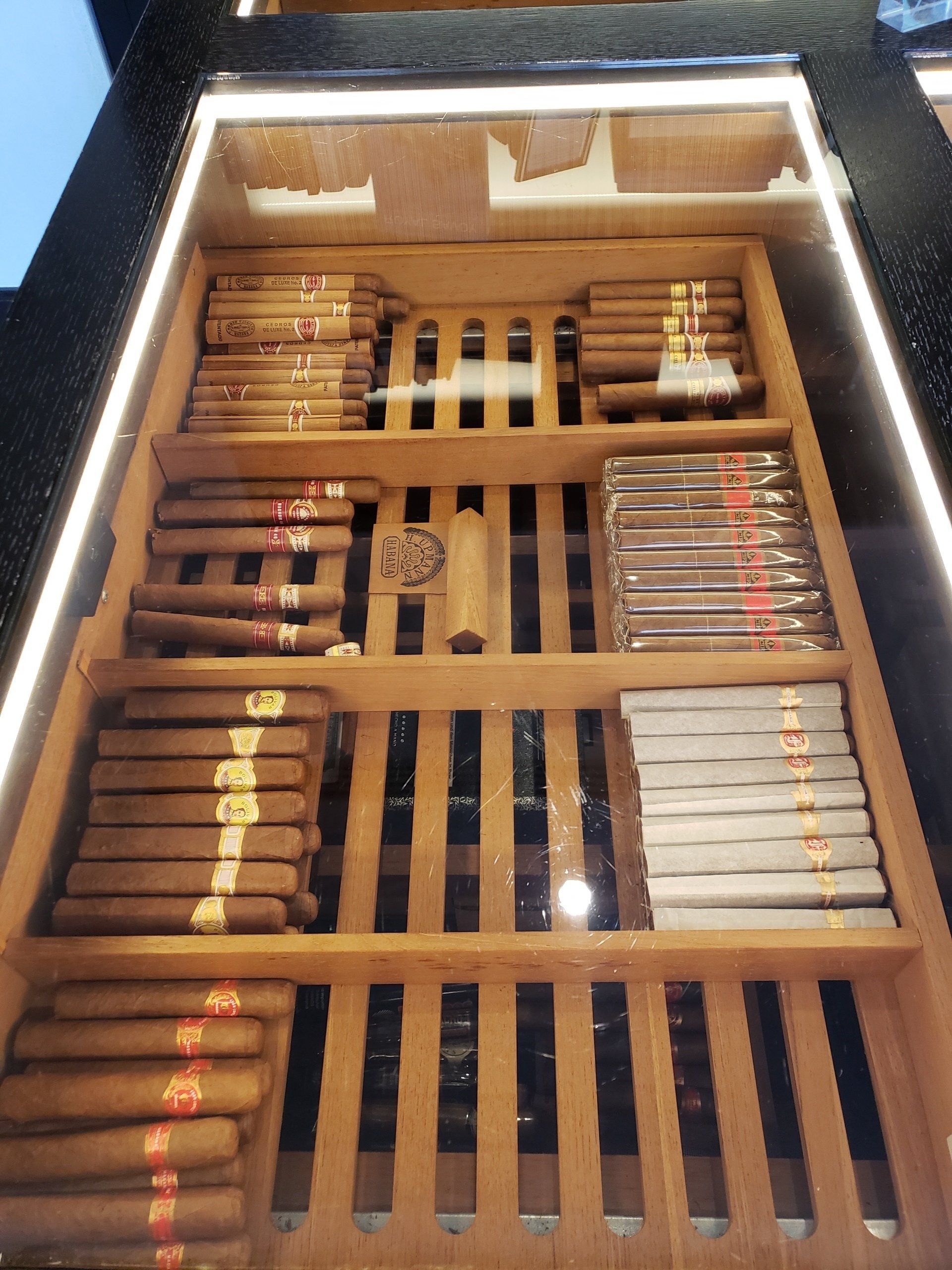 A display case filled with many different types of cigars