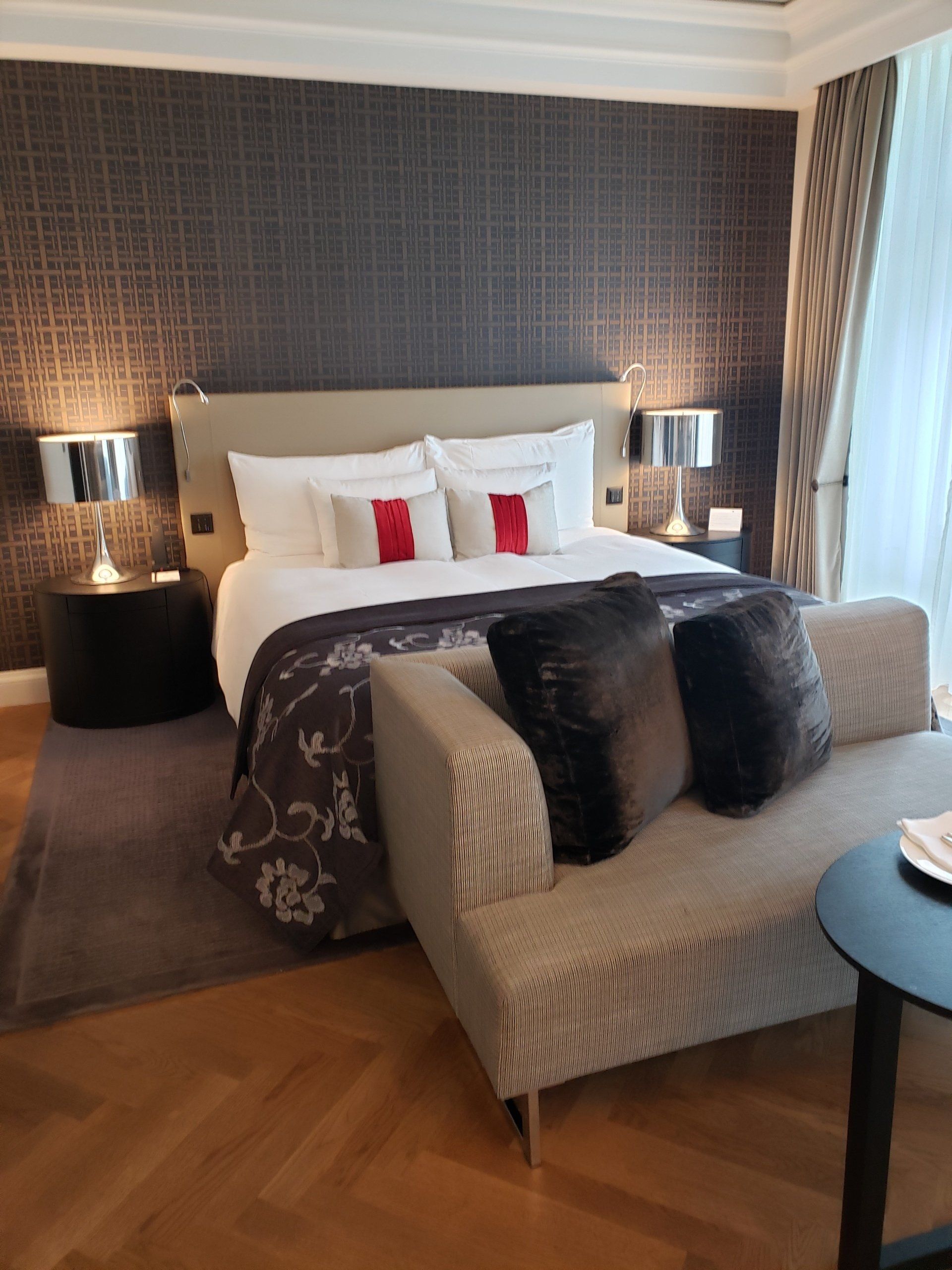 A hotel room with a large bed and a couch