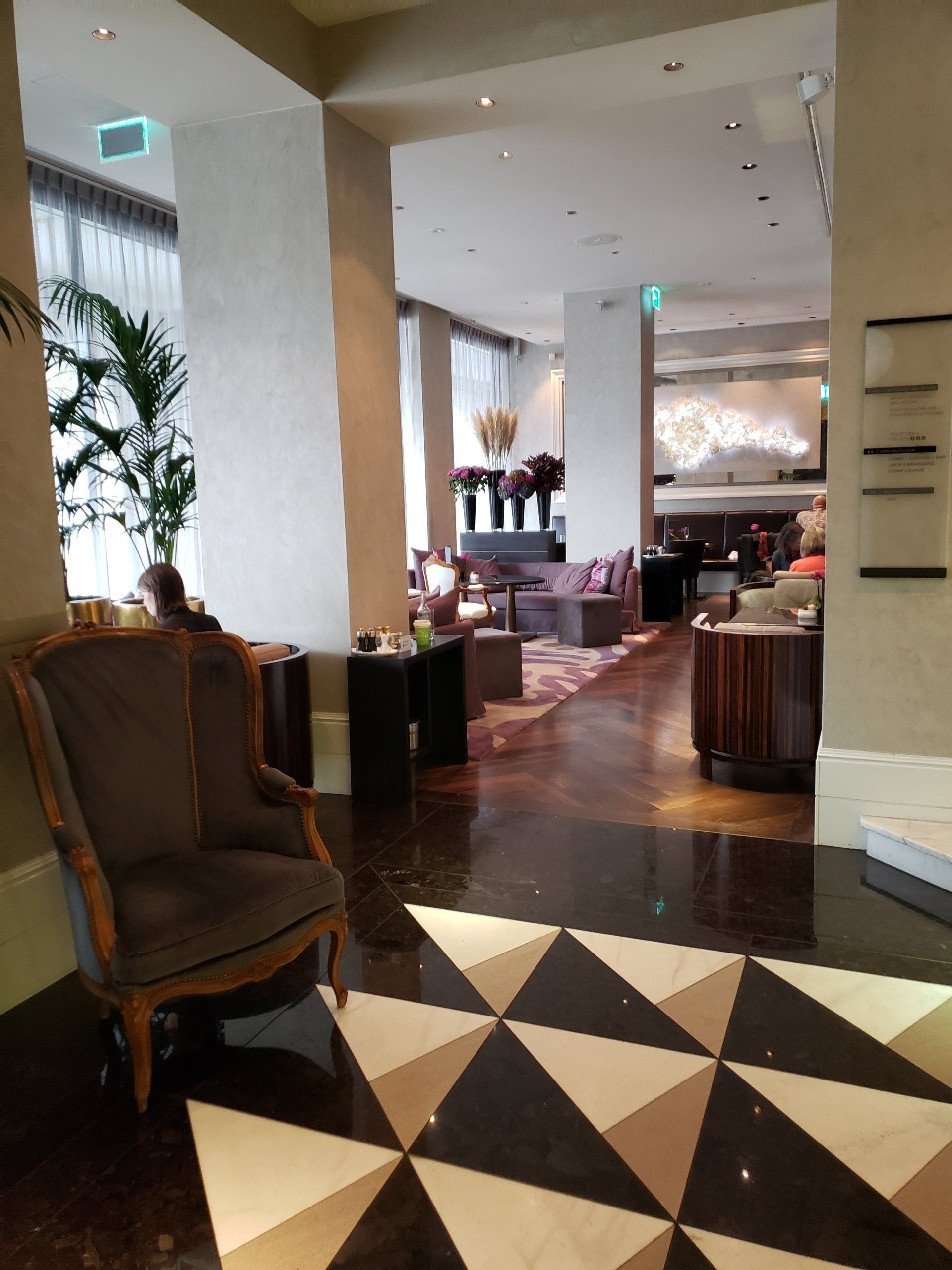 A chair is sitting in a lobby of a hotel