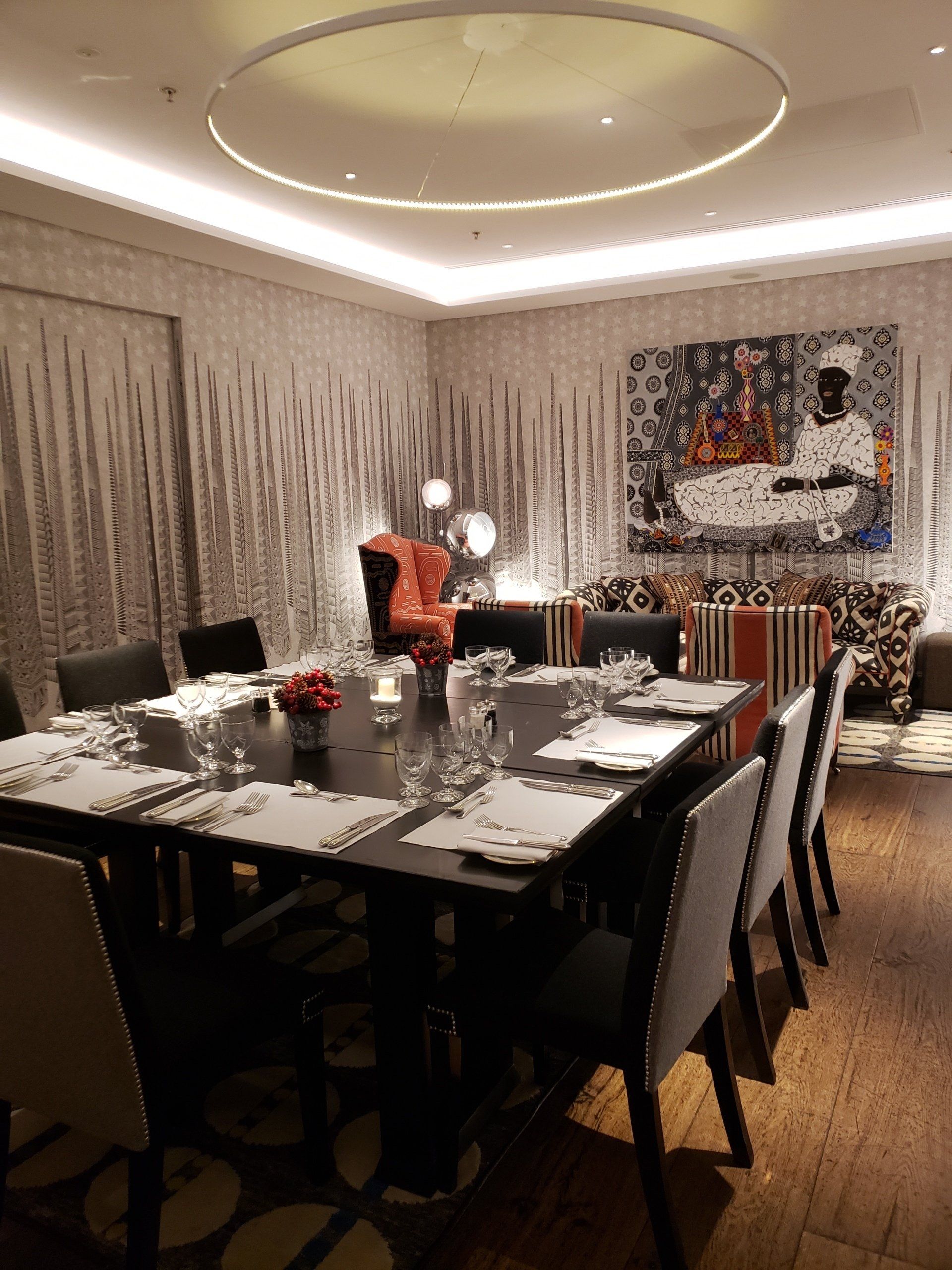 A dining room with a long table and chairs