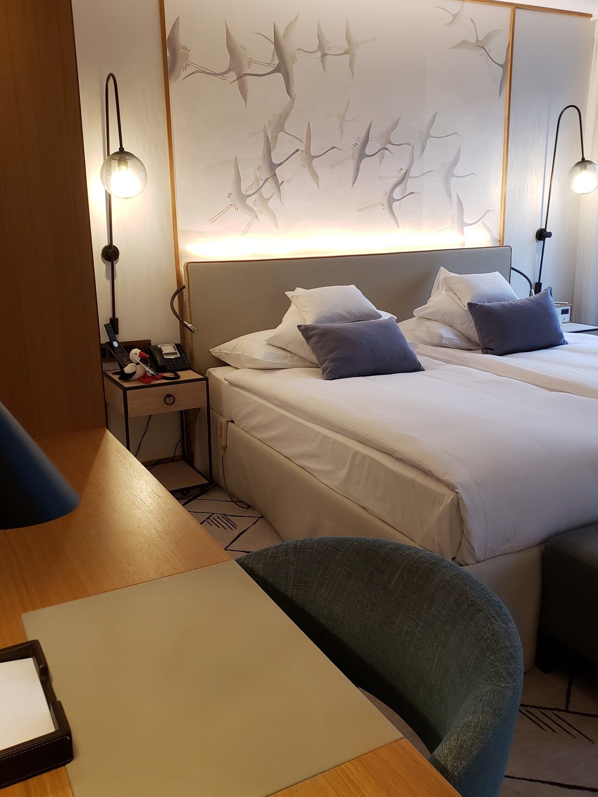 A hotel room with two beds and a desk
