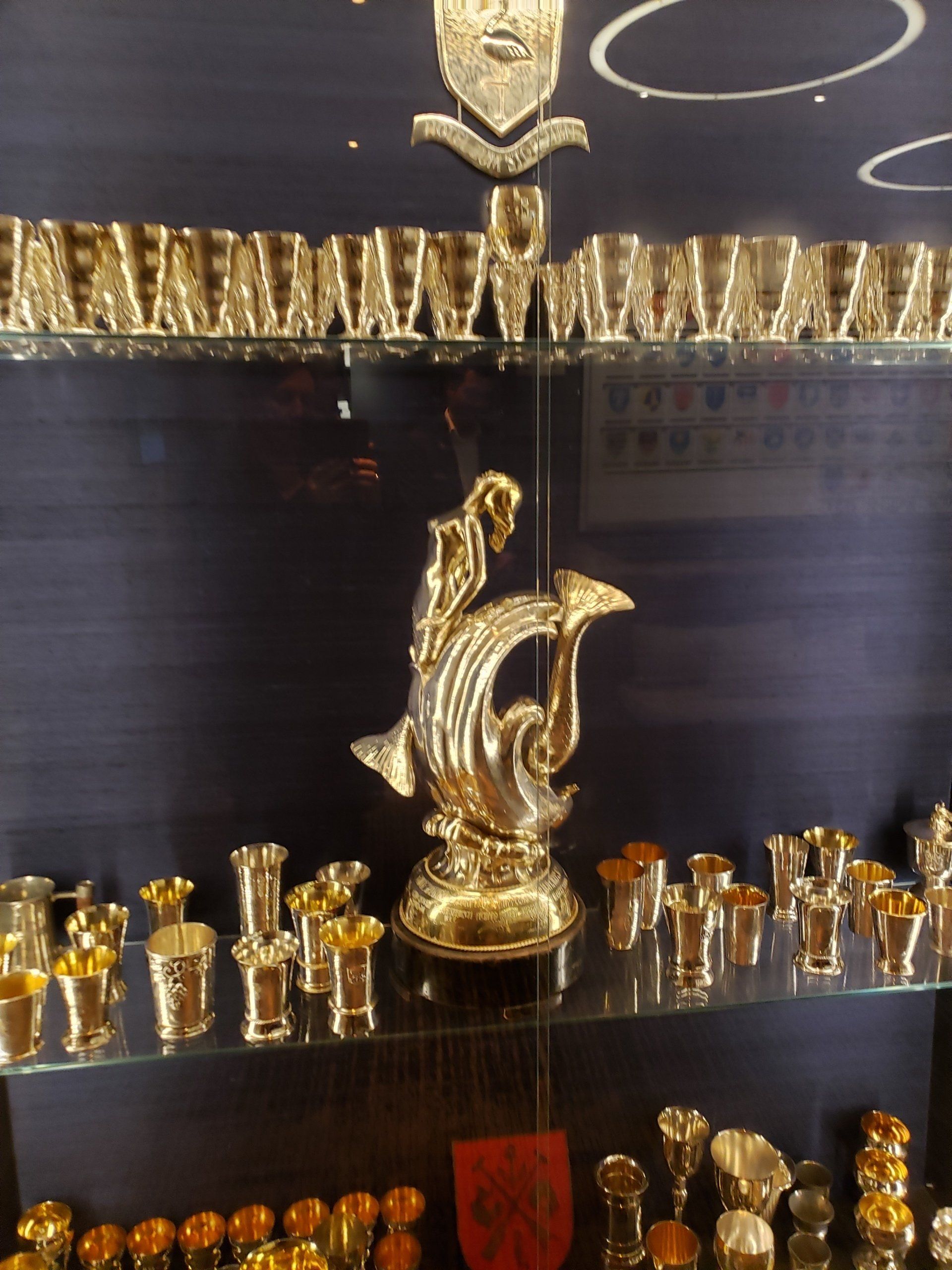 A display case with a statue of a dolphin on top