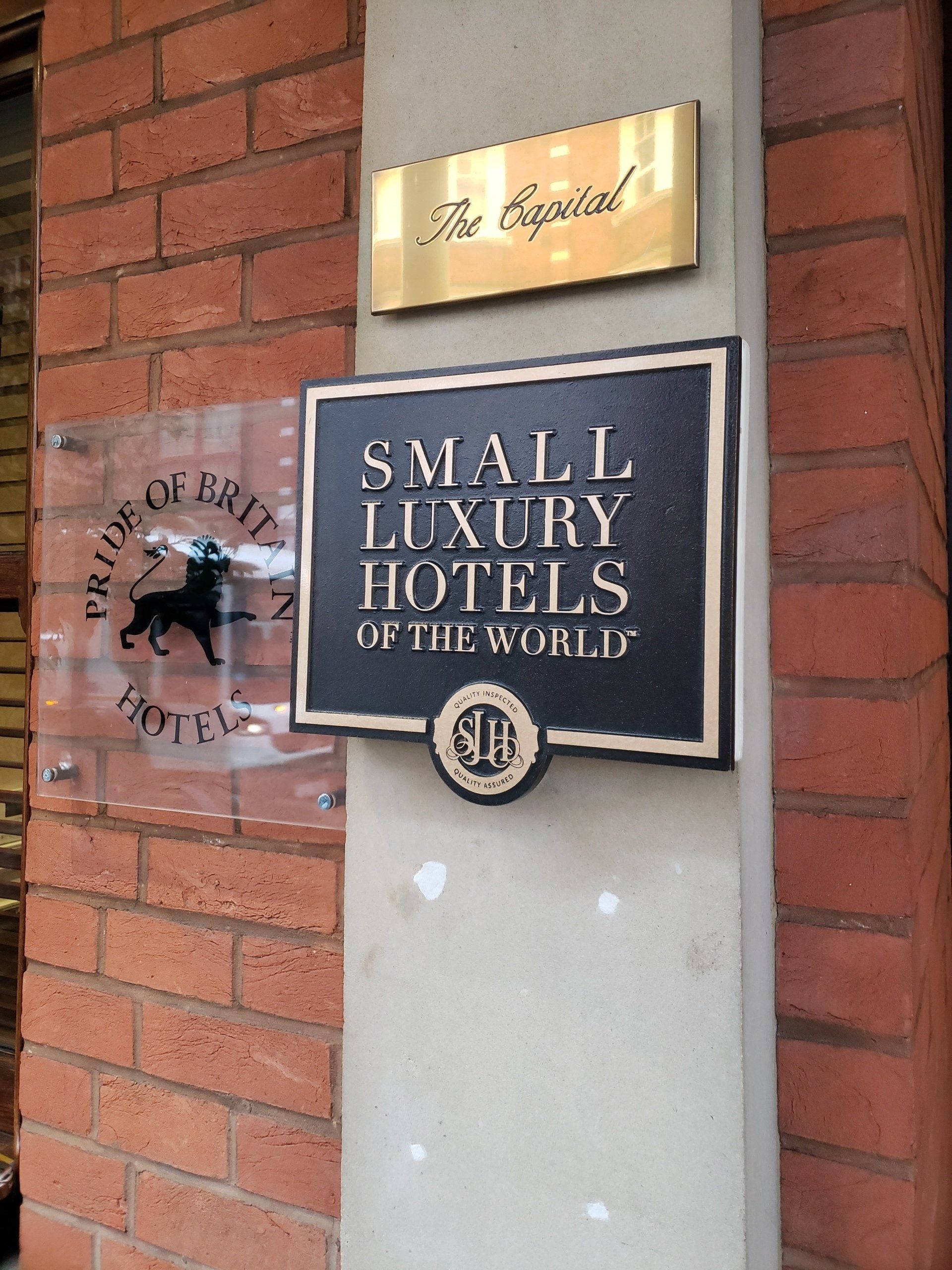 Small luxury hotels of the world sign on a brick wall