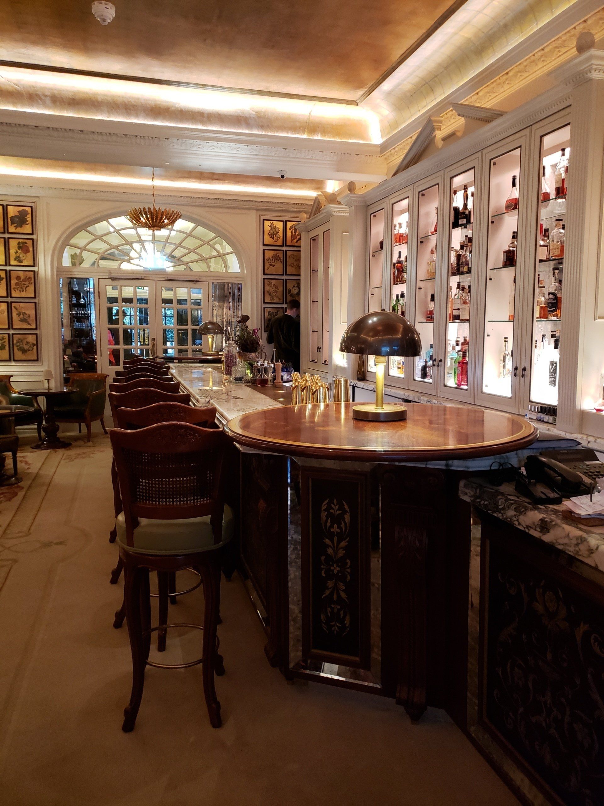 A long bar in a restaurant with a lamp on it