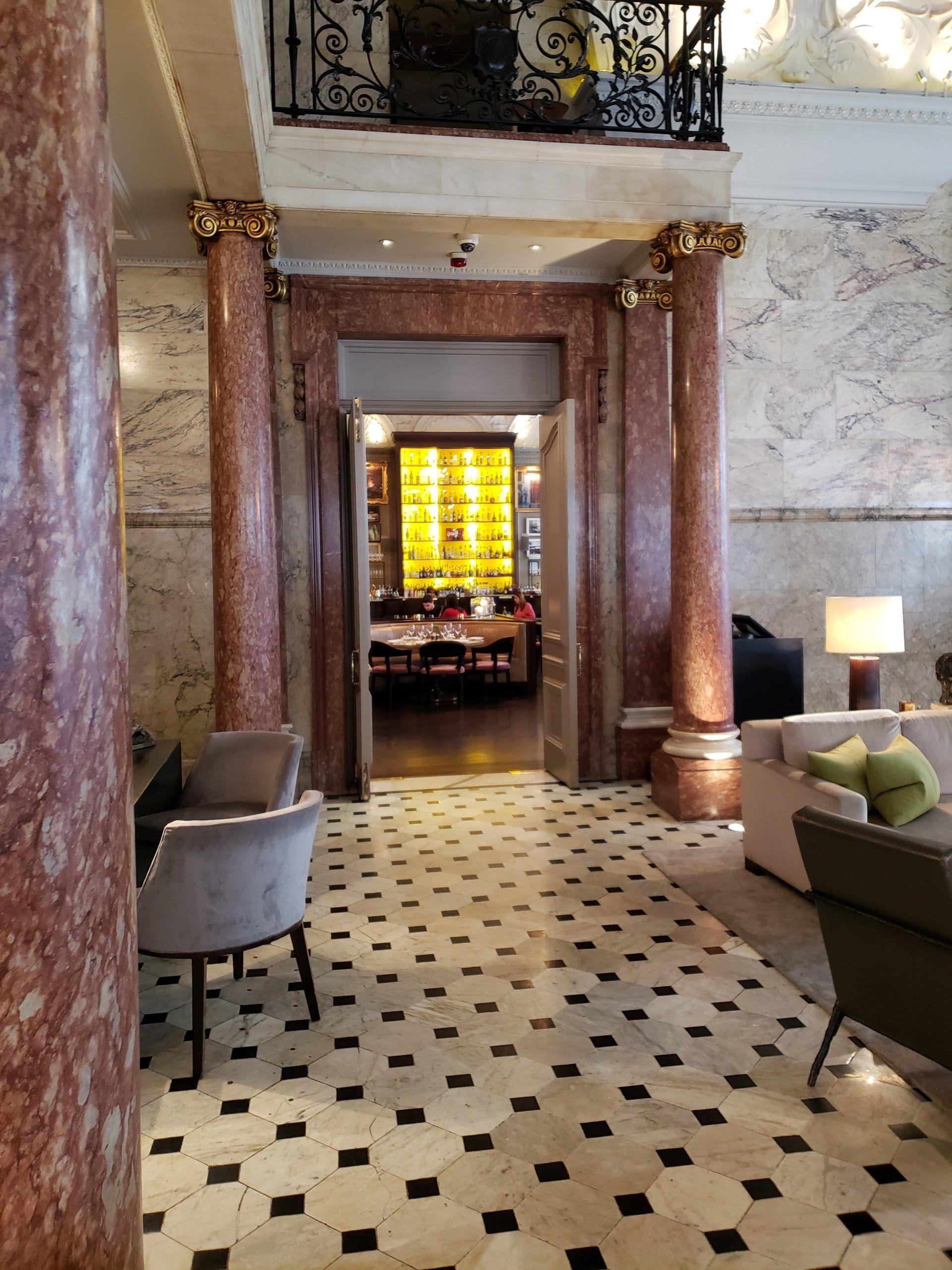 A hallway with columns and a checkered floor