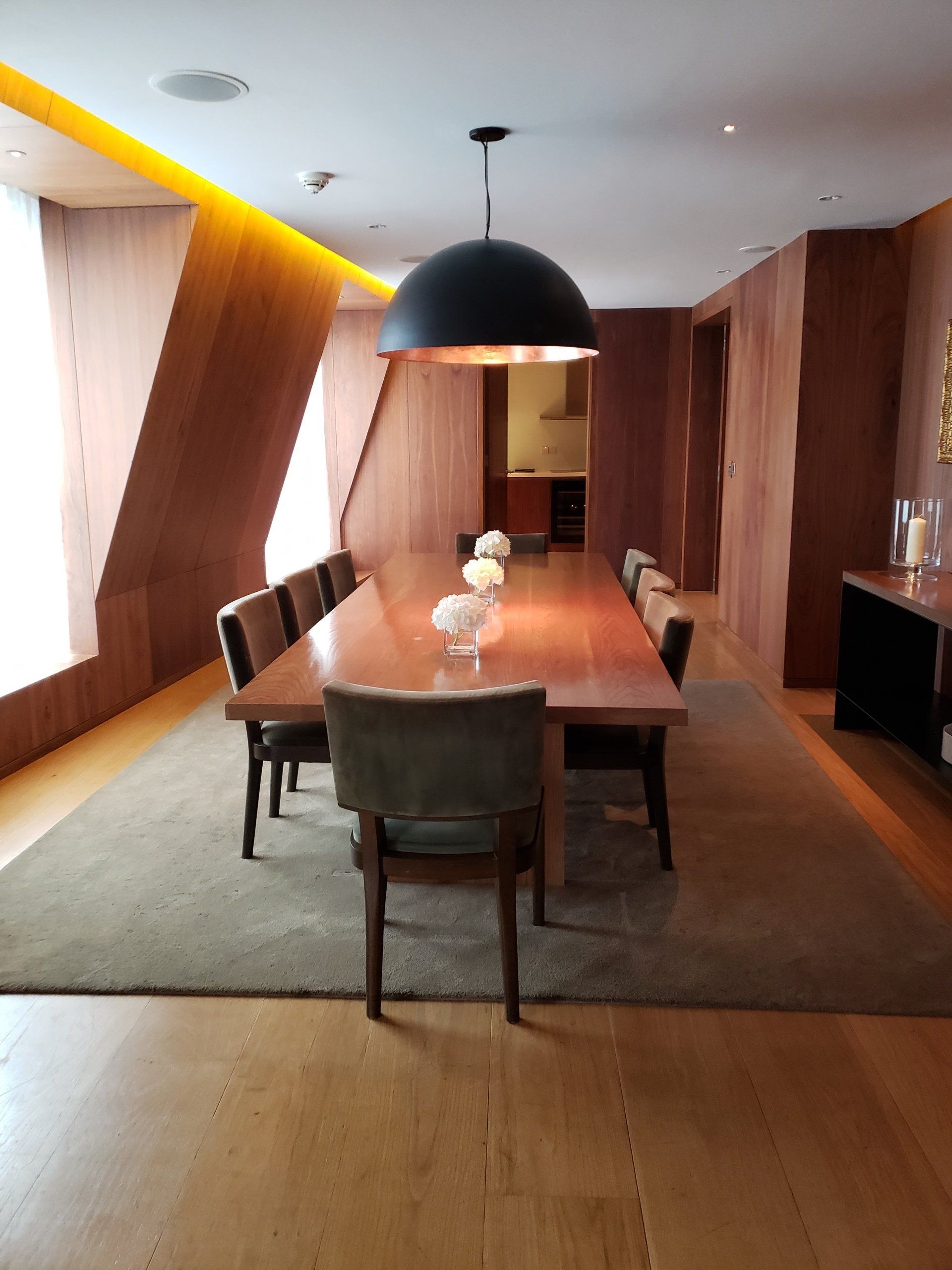 A dining room with a long table and chairs