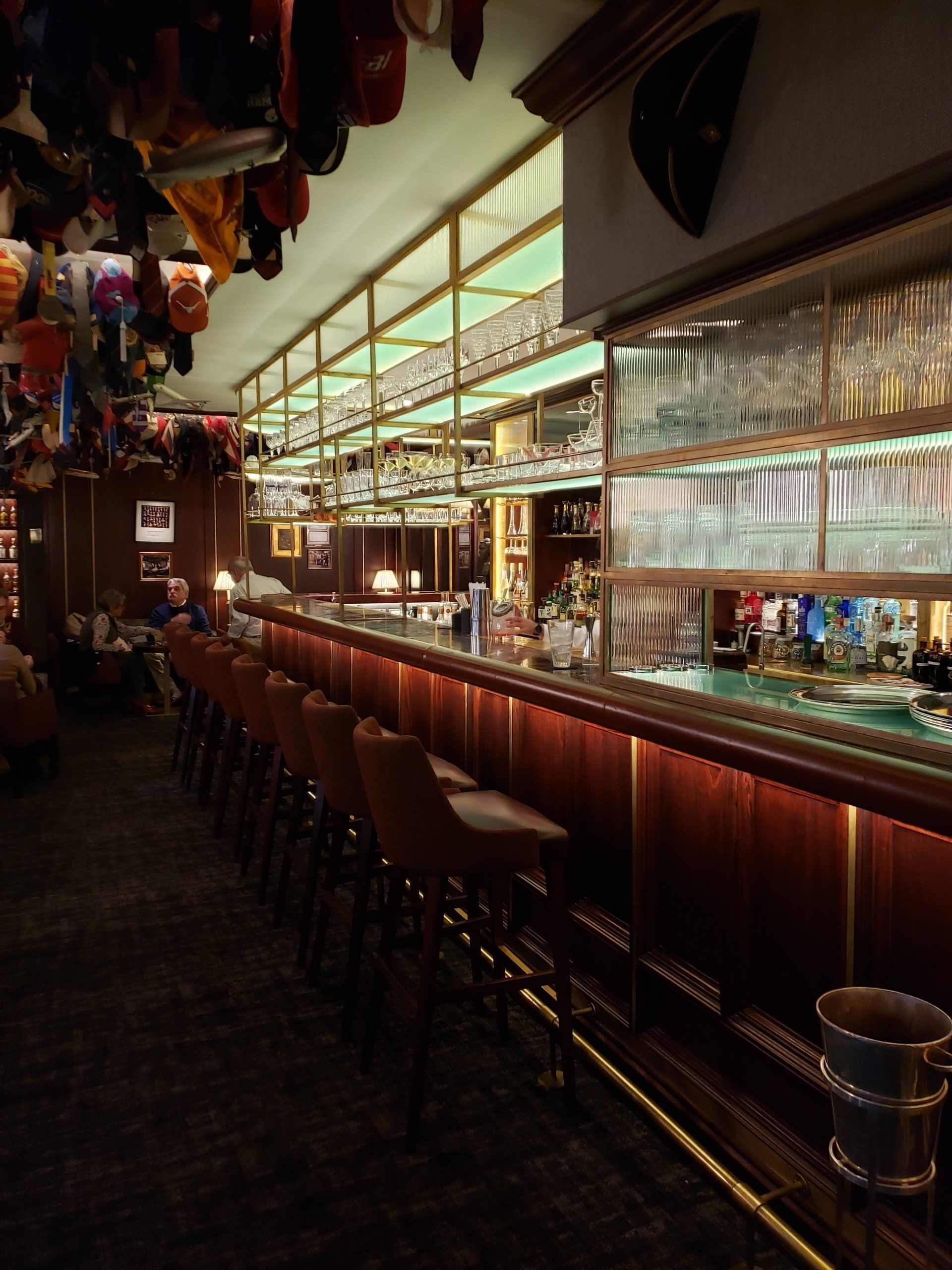 A long bar in a restaurant with balloons hanging from the ceiling