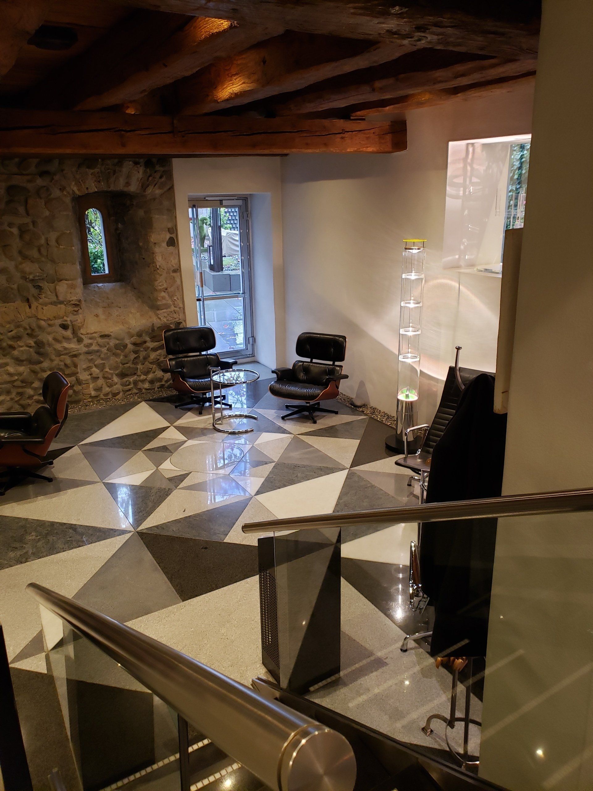 A living room with a checkered floor and chairs