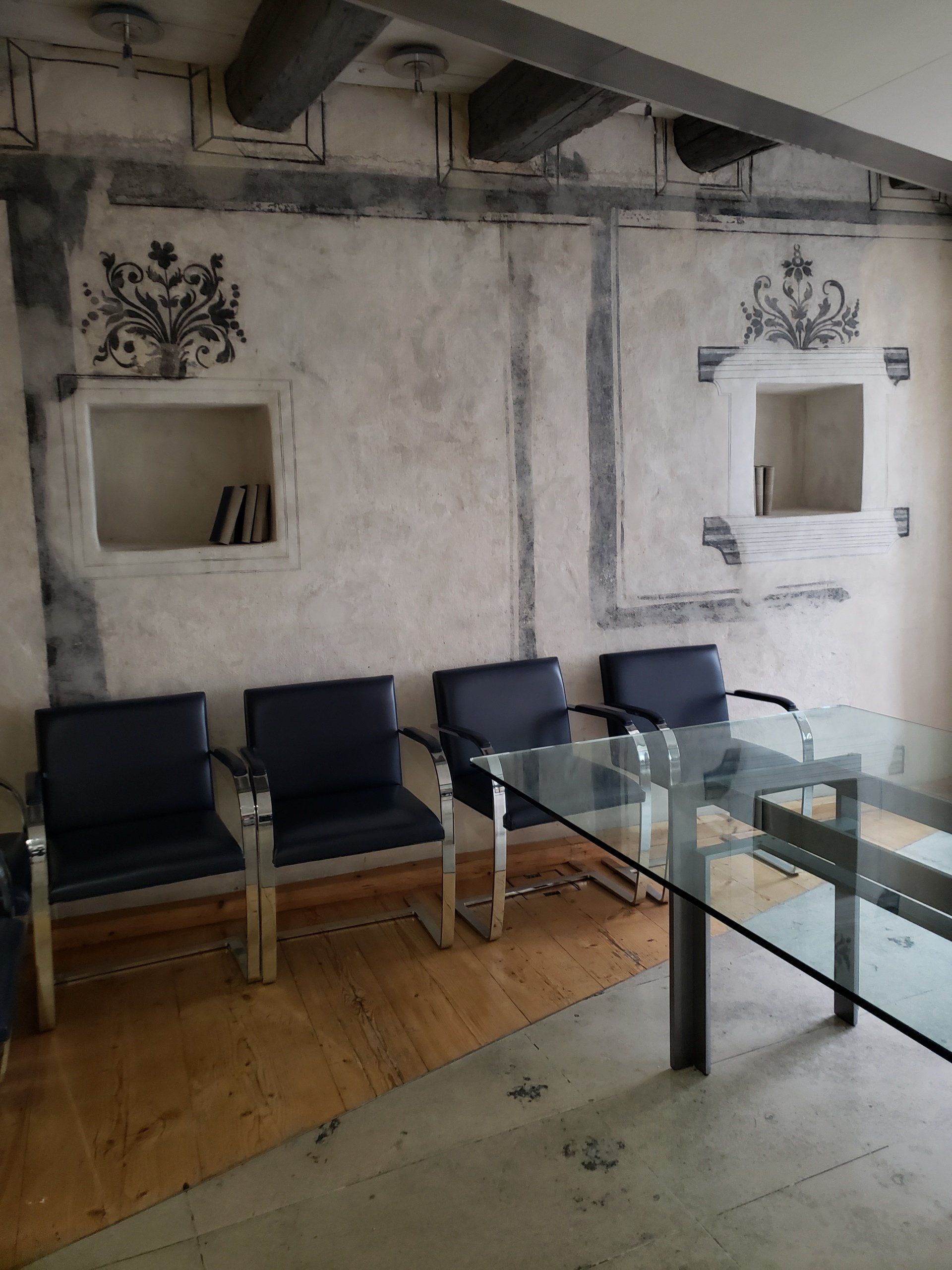 A room with a glass table and chairs in it