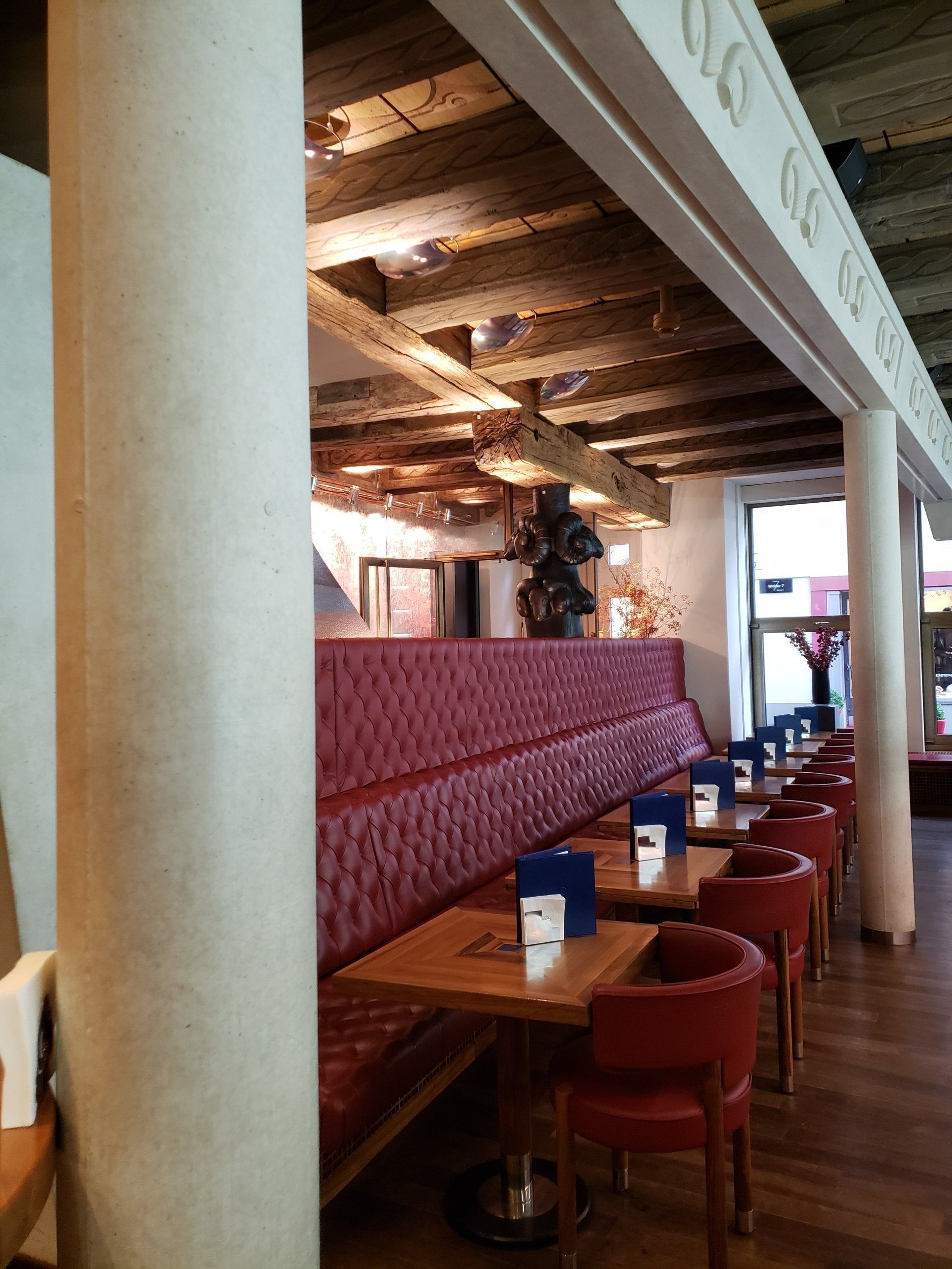 A restaurant with tables and chairs and a sign that says ' uc ' on it