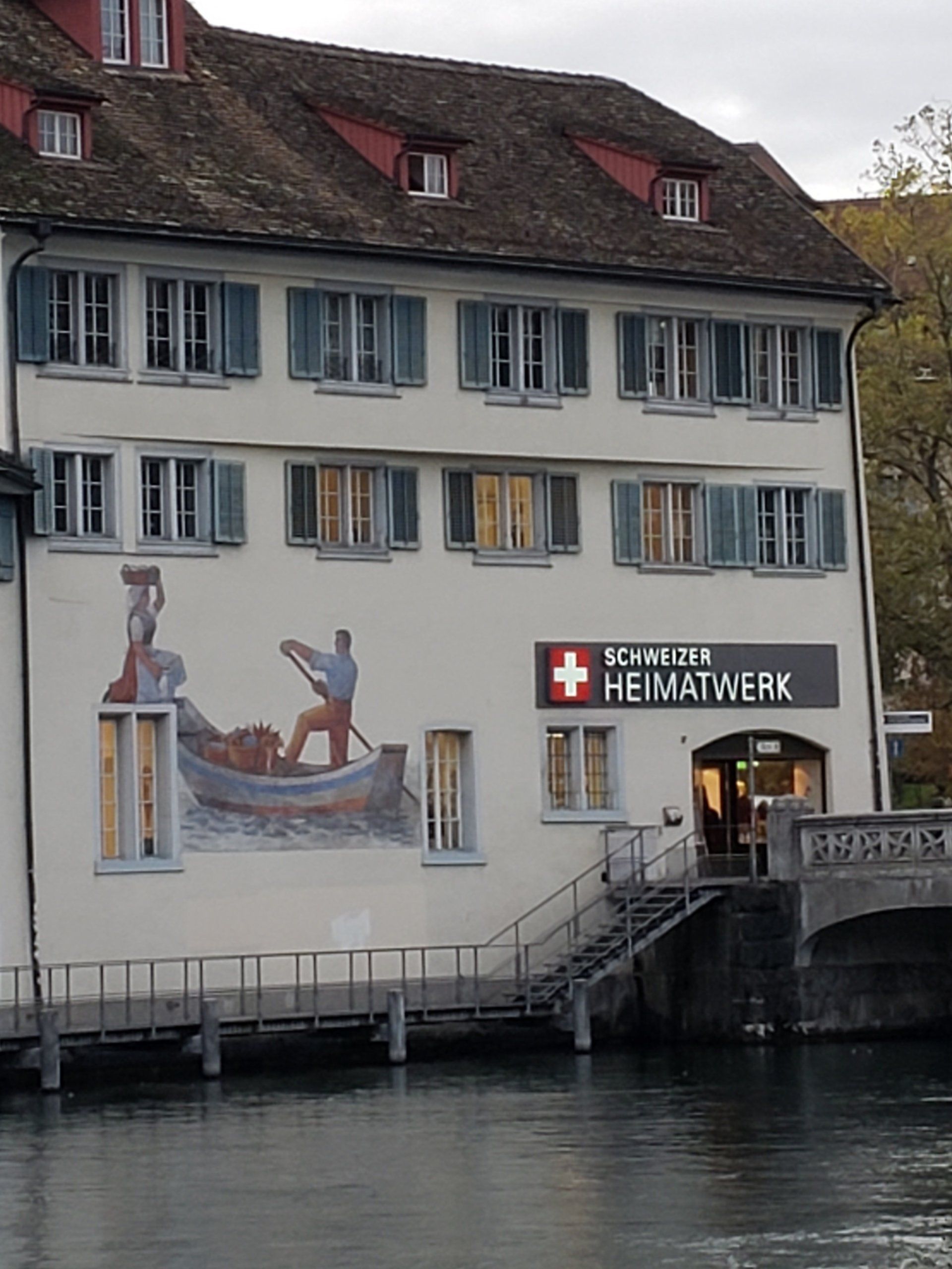A white building with a sign that says ' schweiz ' on it