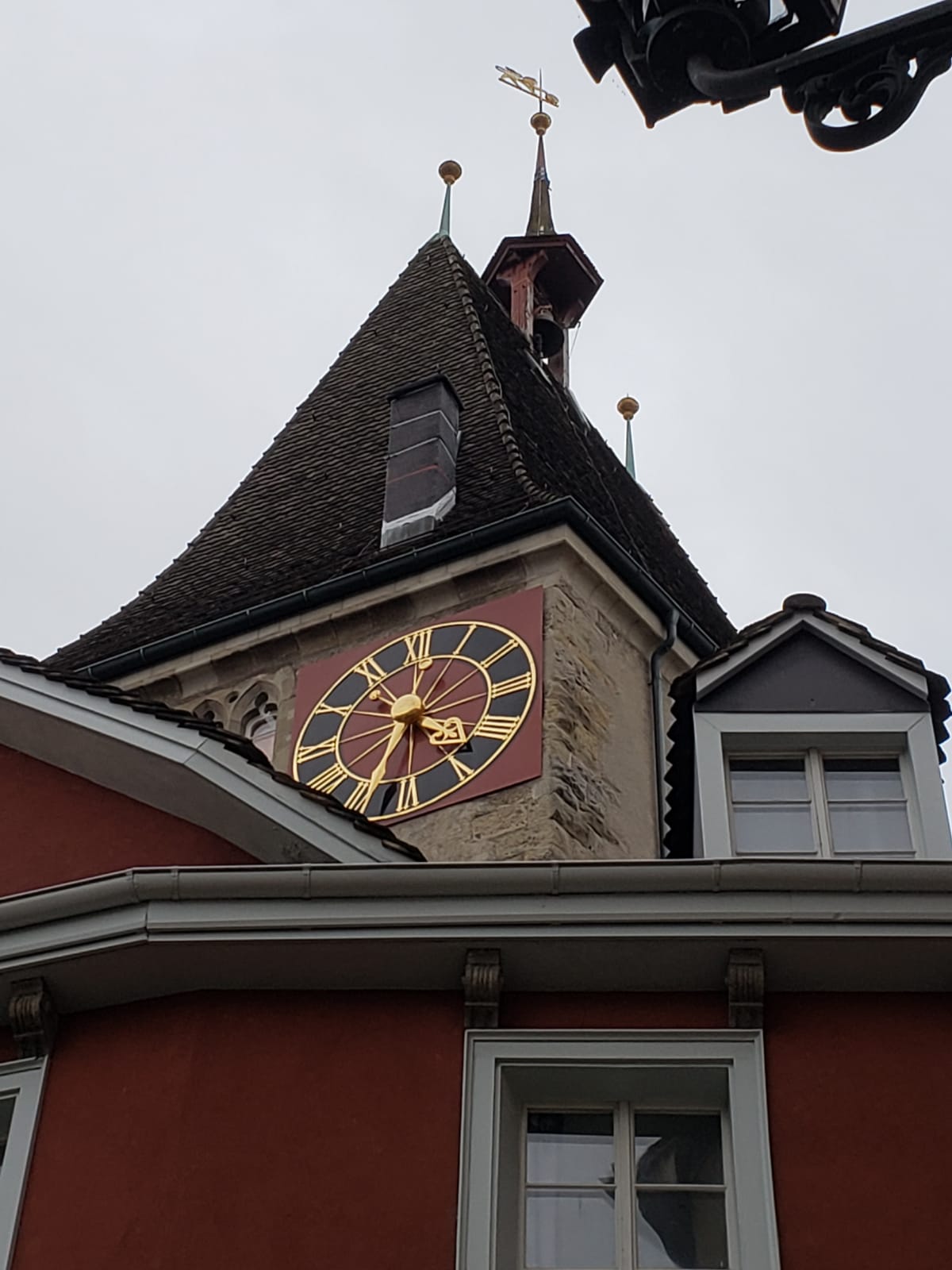 A clock on the side of a building shows the time as 4:20