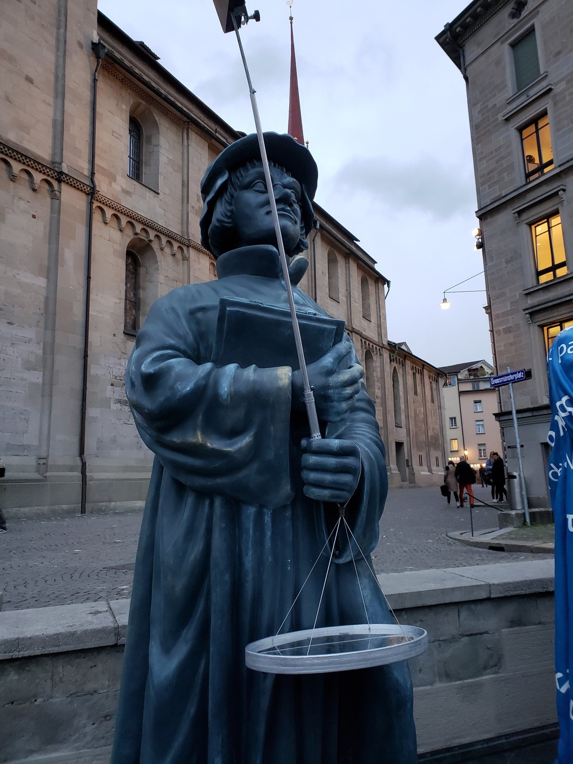 A statue of a man holding a book and a scale