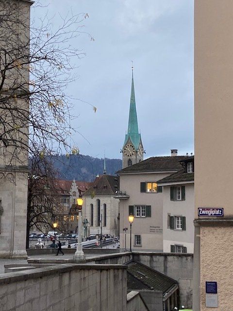 A clock tower is visible in the distance behind a building with a sign that says dampfstrasse