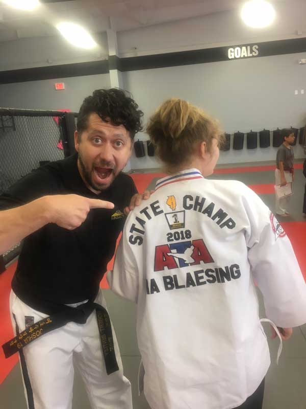 Mia receives her state champ lettered jacket in weapons for 2018 – she rallied back from her injuries to win the title