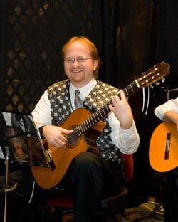Man playing G Major on a classical guitar