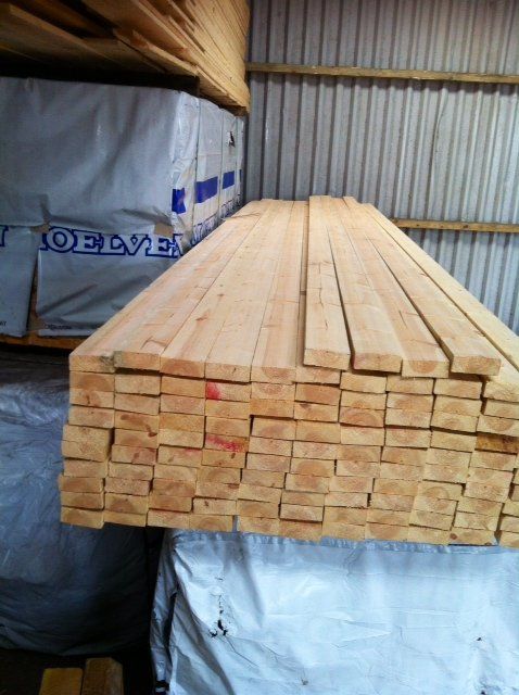 timber beams stacked up in warehouse