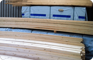 timber beams stacked up in yard
