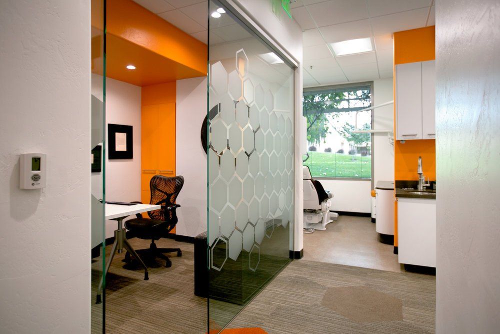 A room with a glass door and a chair in it