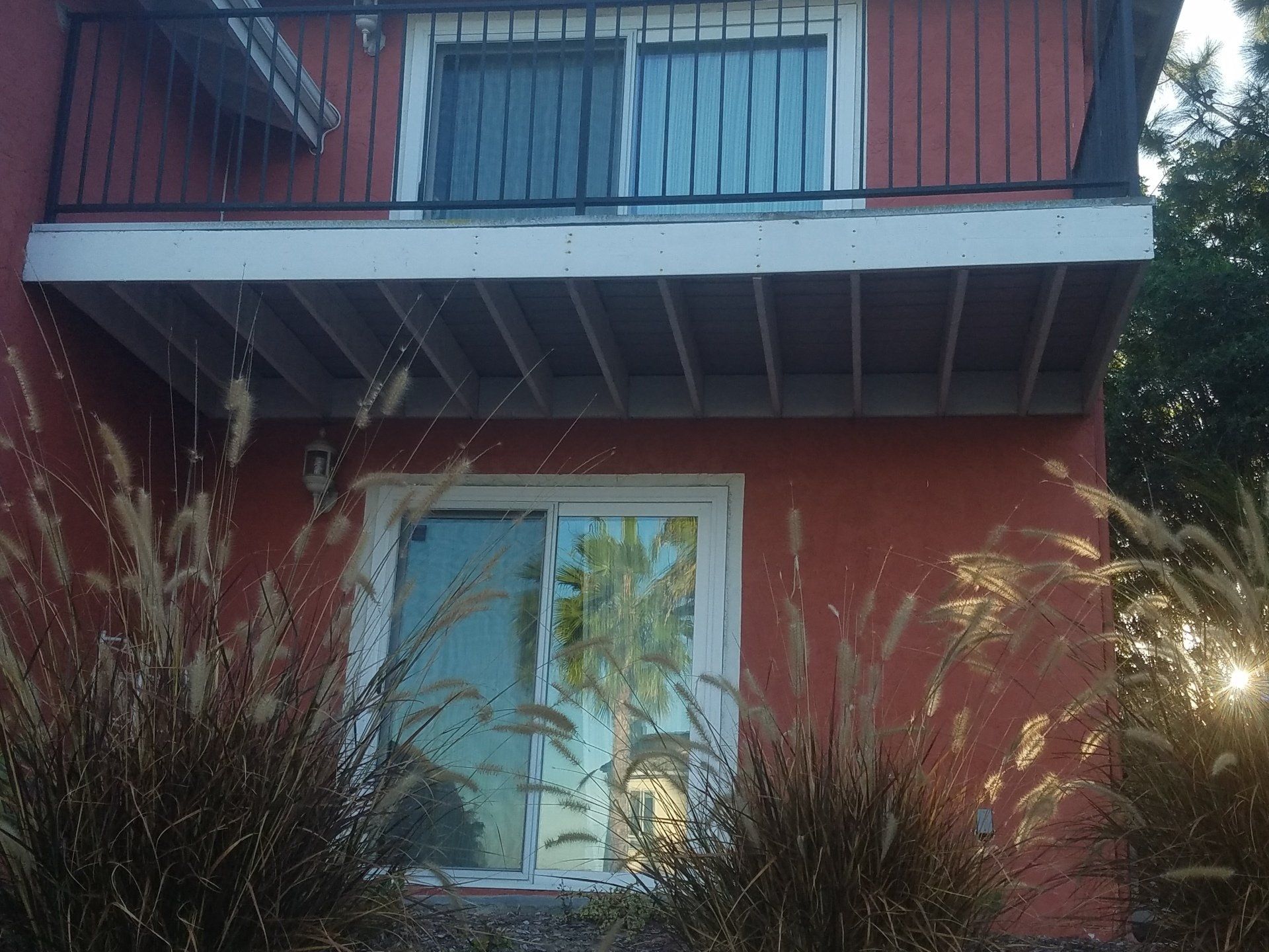 A house with a balcony and a sliding glass door