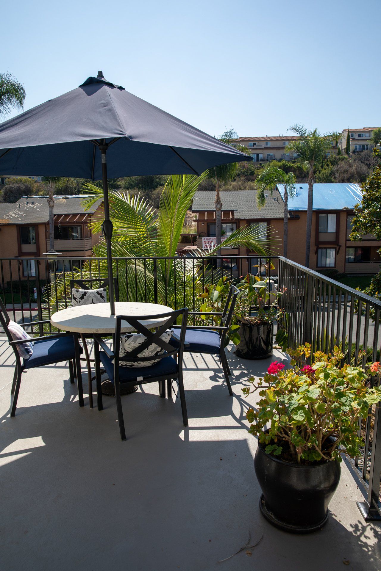 A patio with a table and chairs under an umbrella