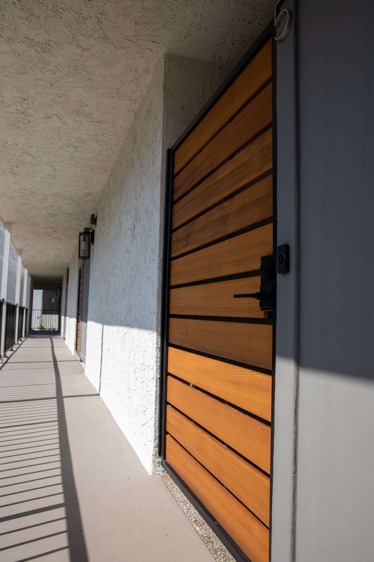 A hallway with a wooden door in the middle