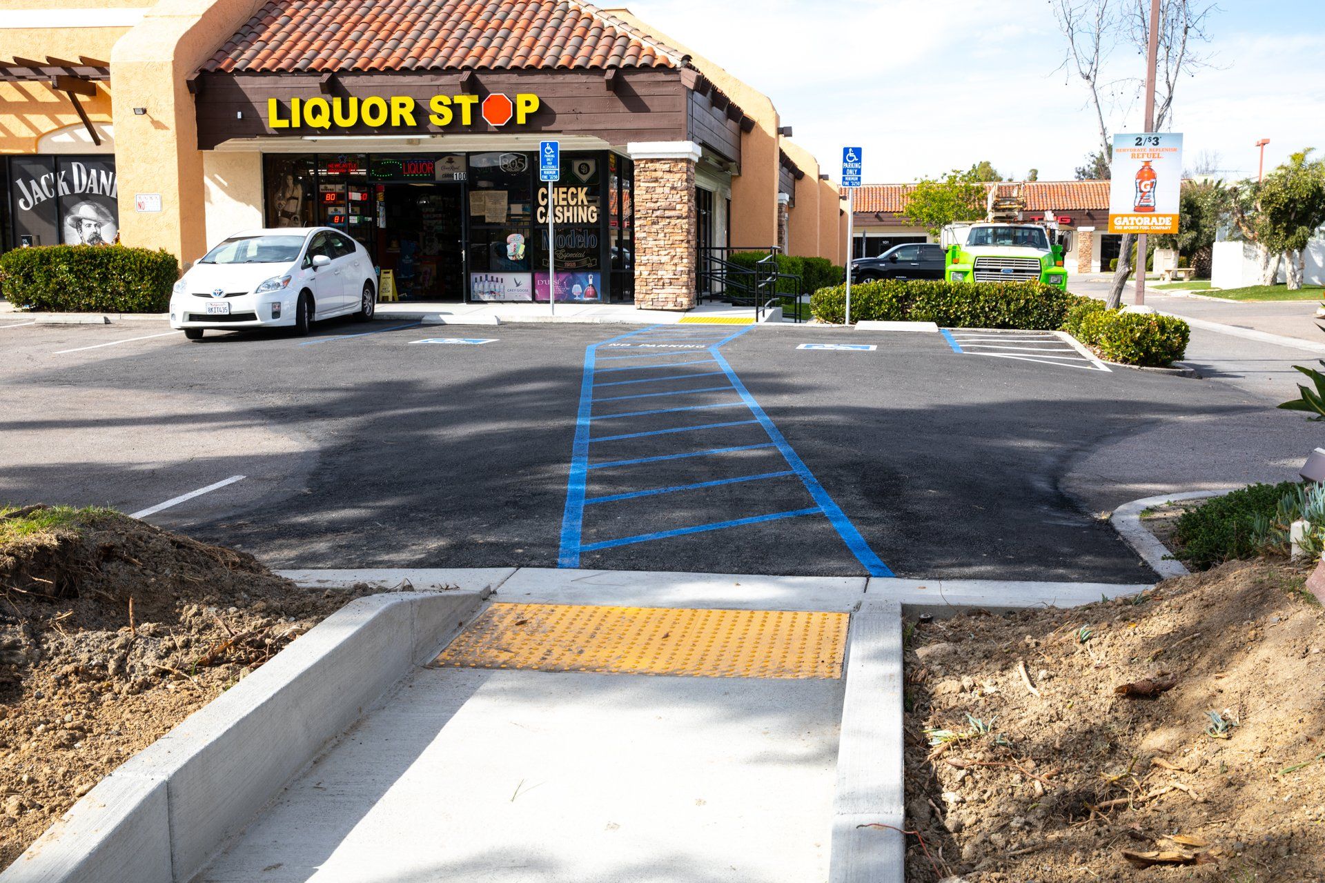 A car is parked in front of a liquor store