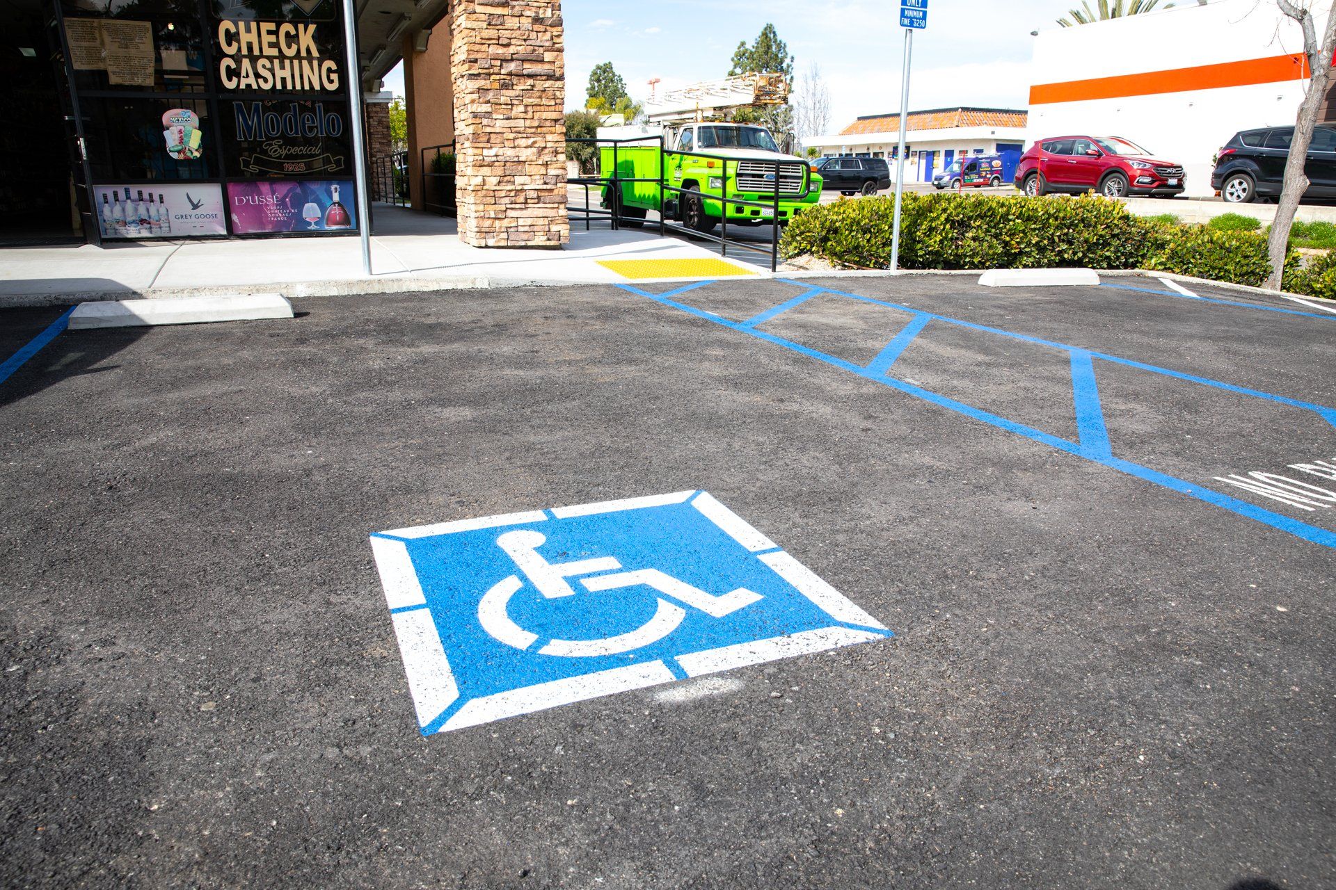 A handicapped parking spot is painted in a parking lot