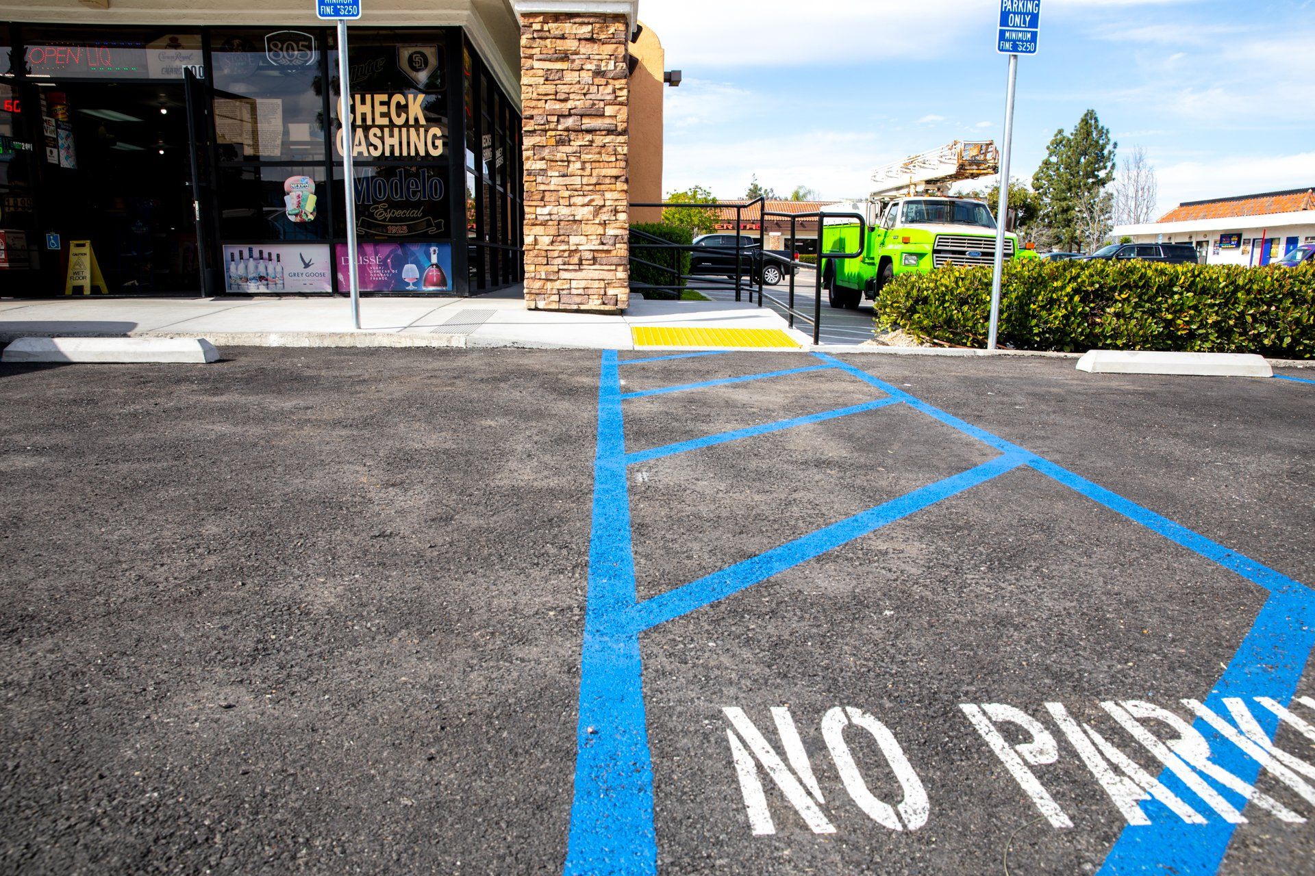 A no parking sign is painted on a parking lot