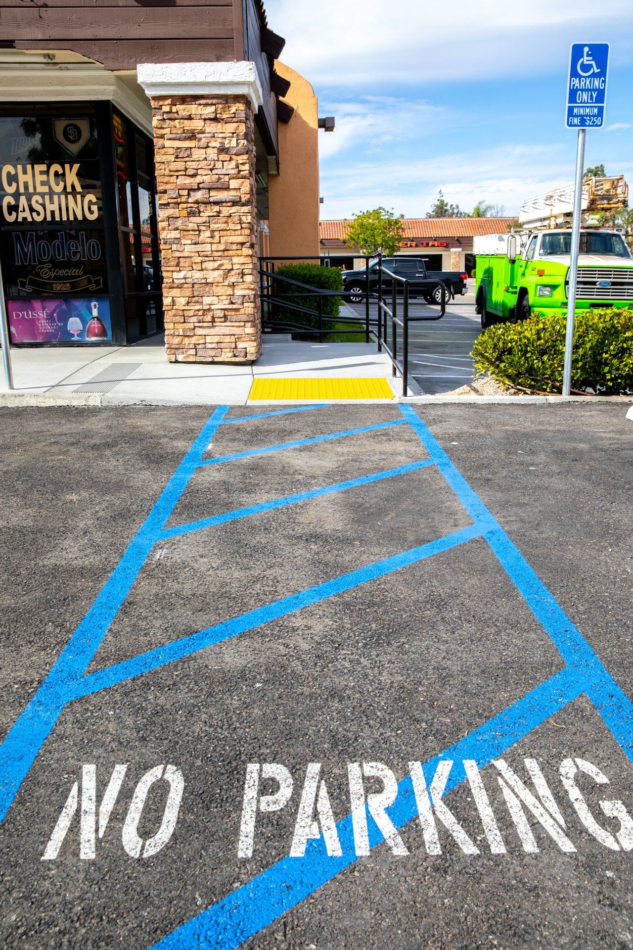 A no parking sign is painted on a parking lot