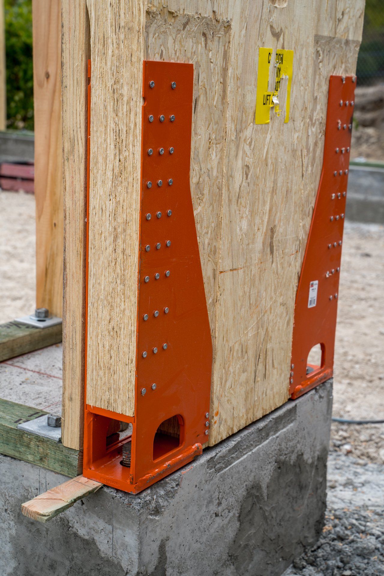 A wooden wall with a metal bracket attached to it