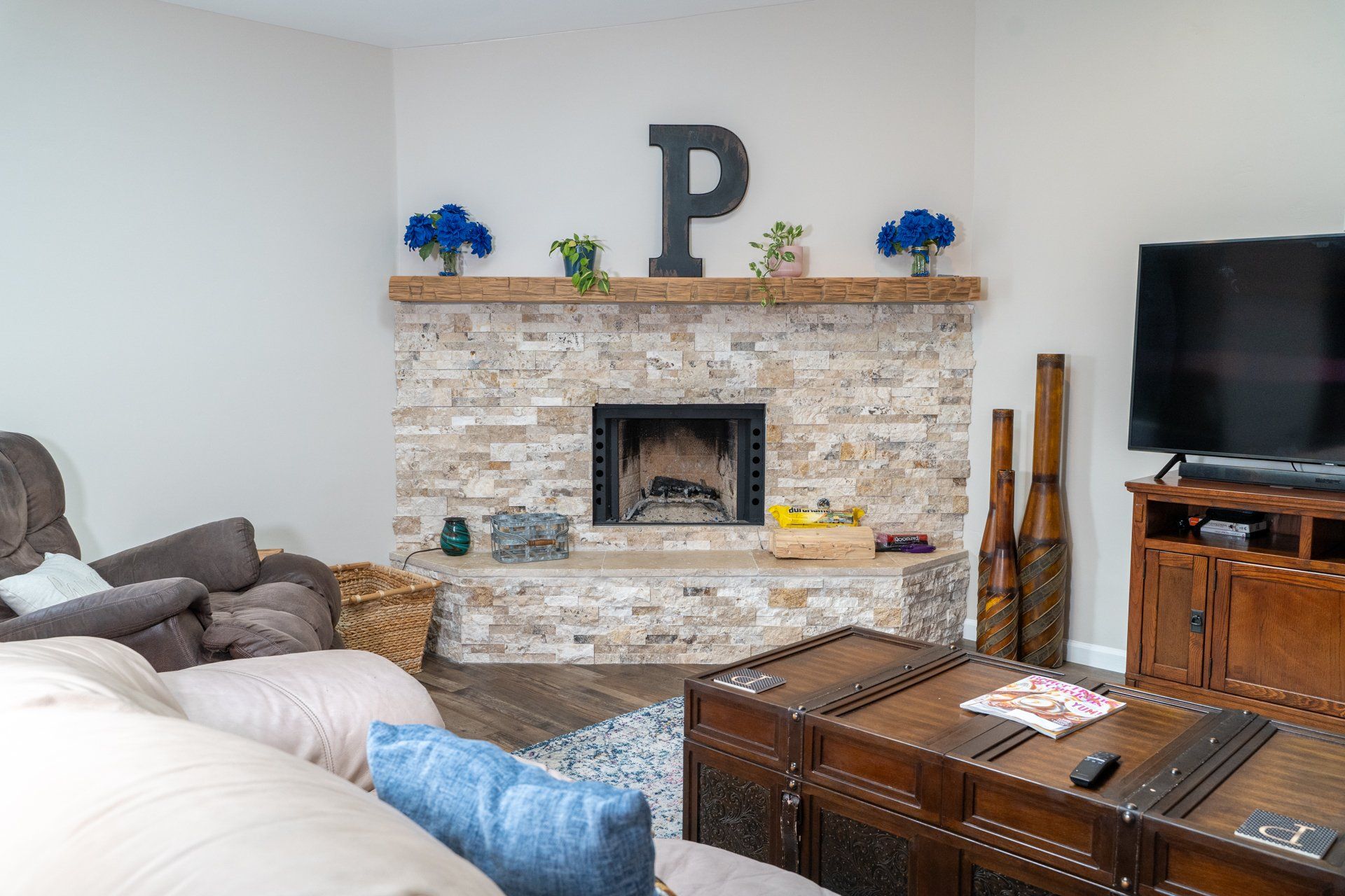 A living room with a fireplace and a flat screen tv.