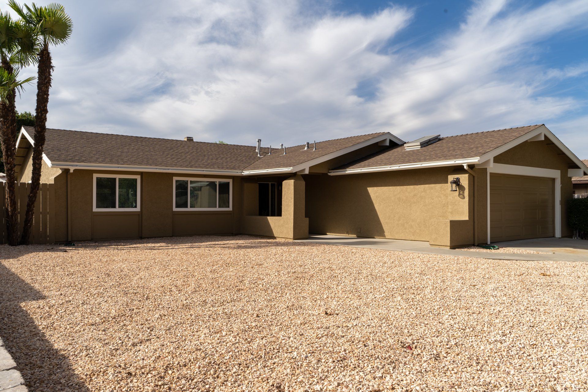 A house with a lot of gravel in front of it