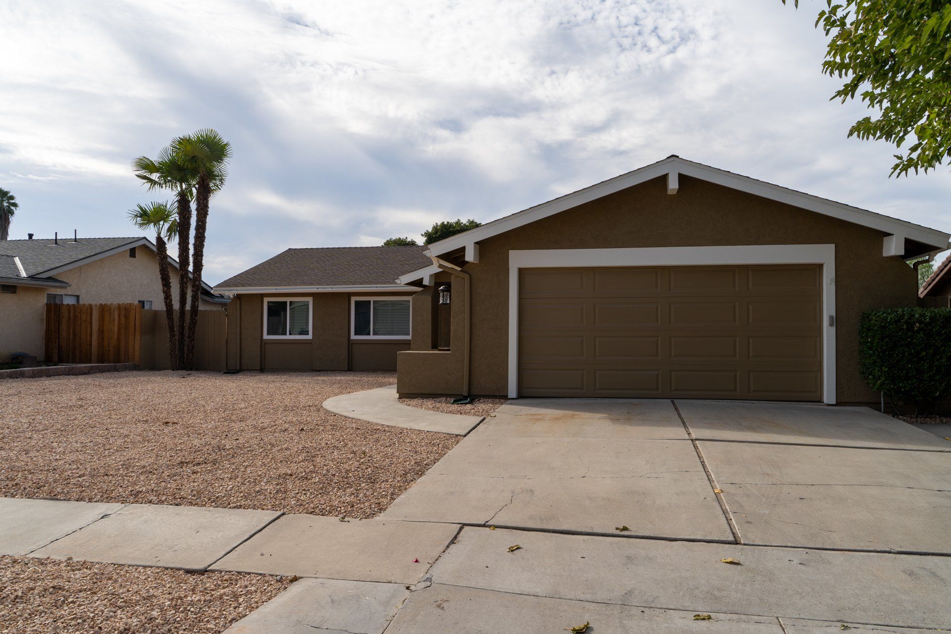 A house with a garage and a driveway in front of it