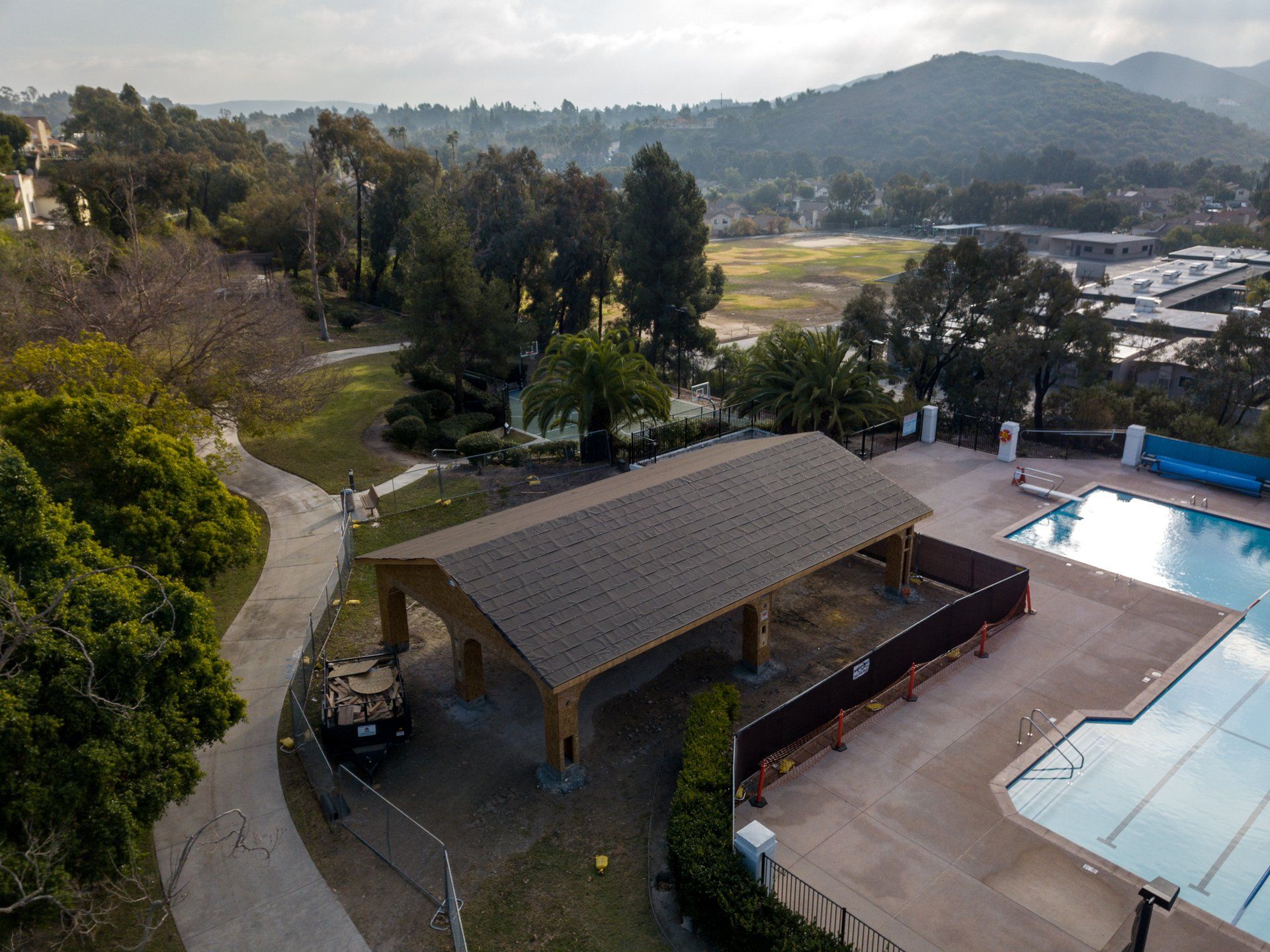 An aerial view of a pavilion and a swimming pool