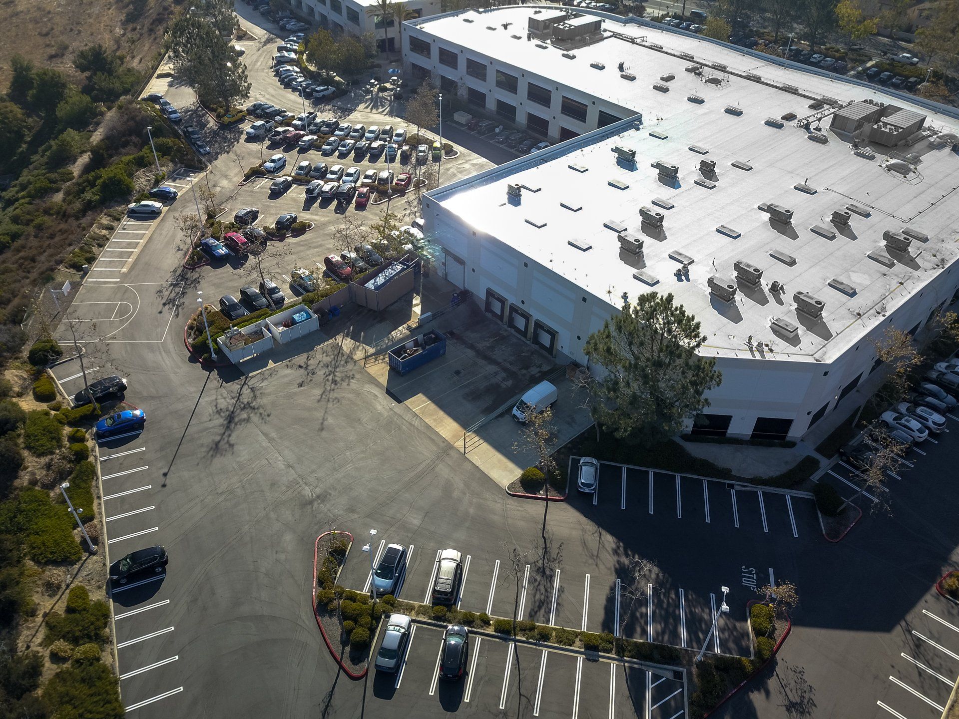 An aerial view of a large building with a parking lot in front of it