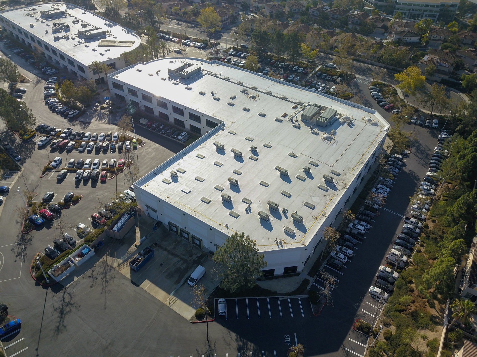 An aerial view of a large building with a parking lot in front of it
