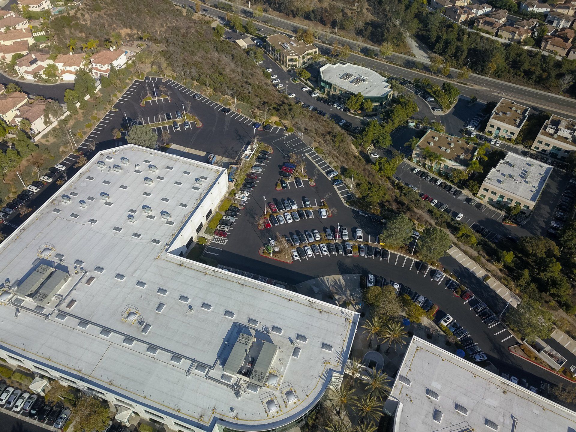An aerial view of a parking lot surrounded by buildings