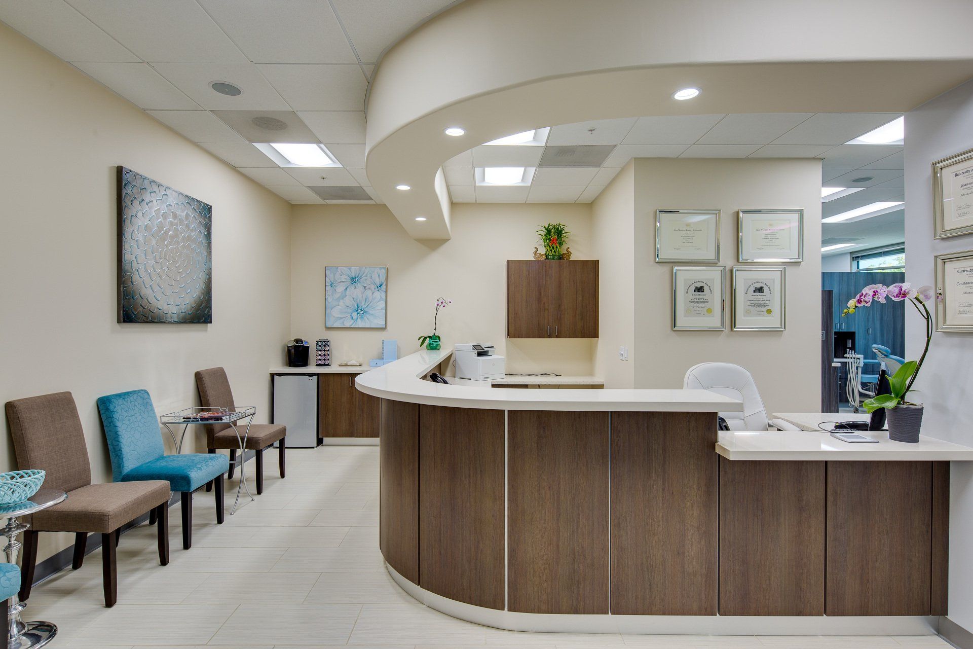 A waiting room with a reception desk and chairs.