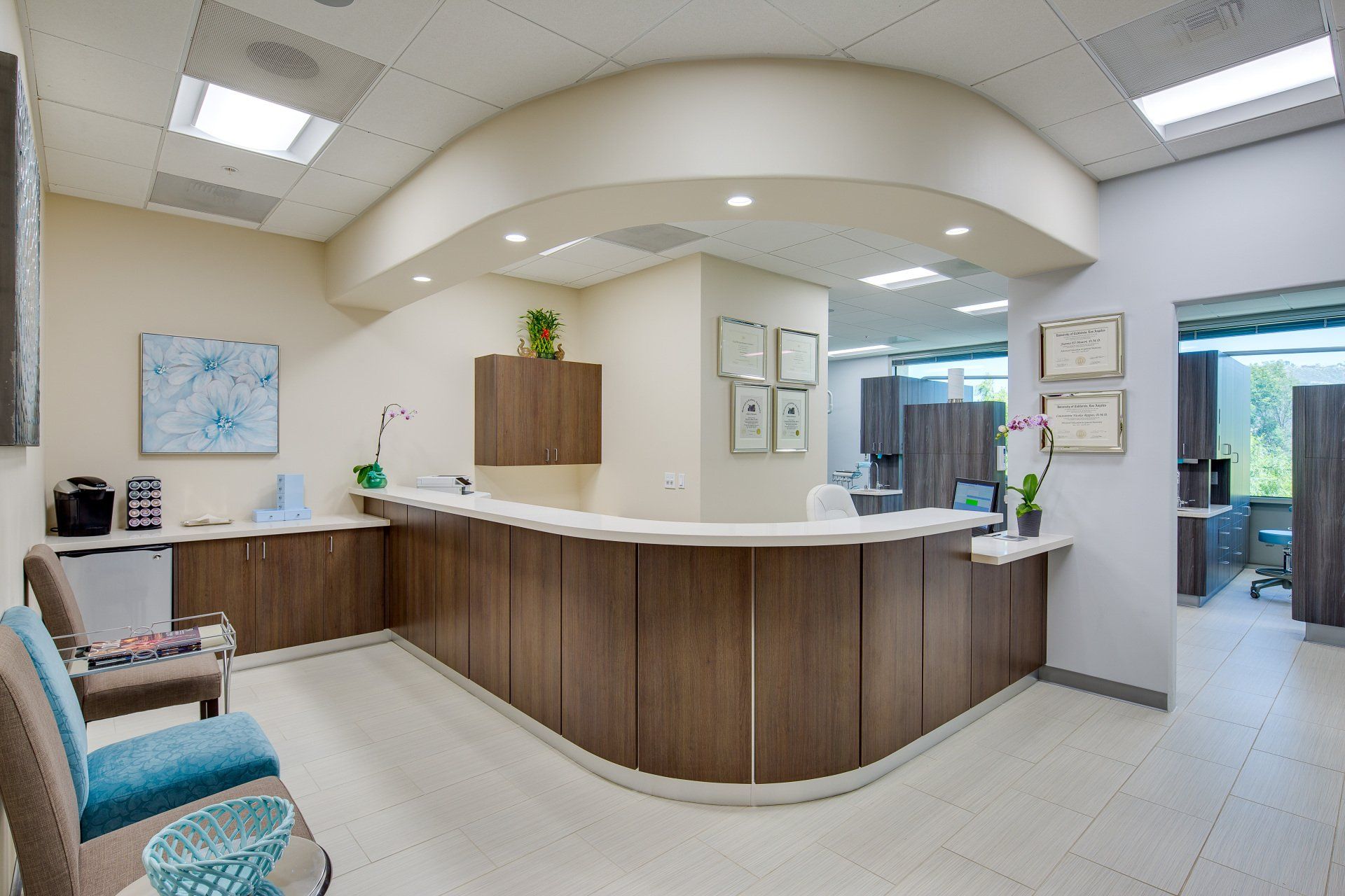 A waiting room with a counter and chairs in a hospital.