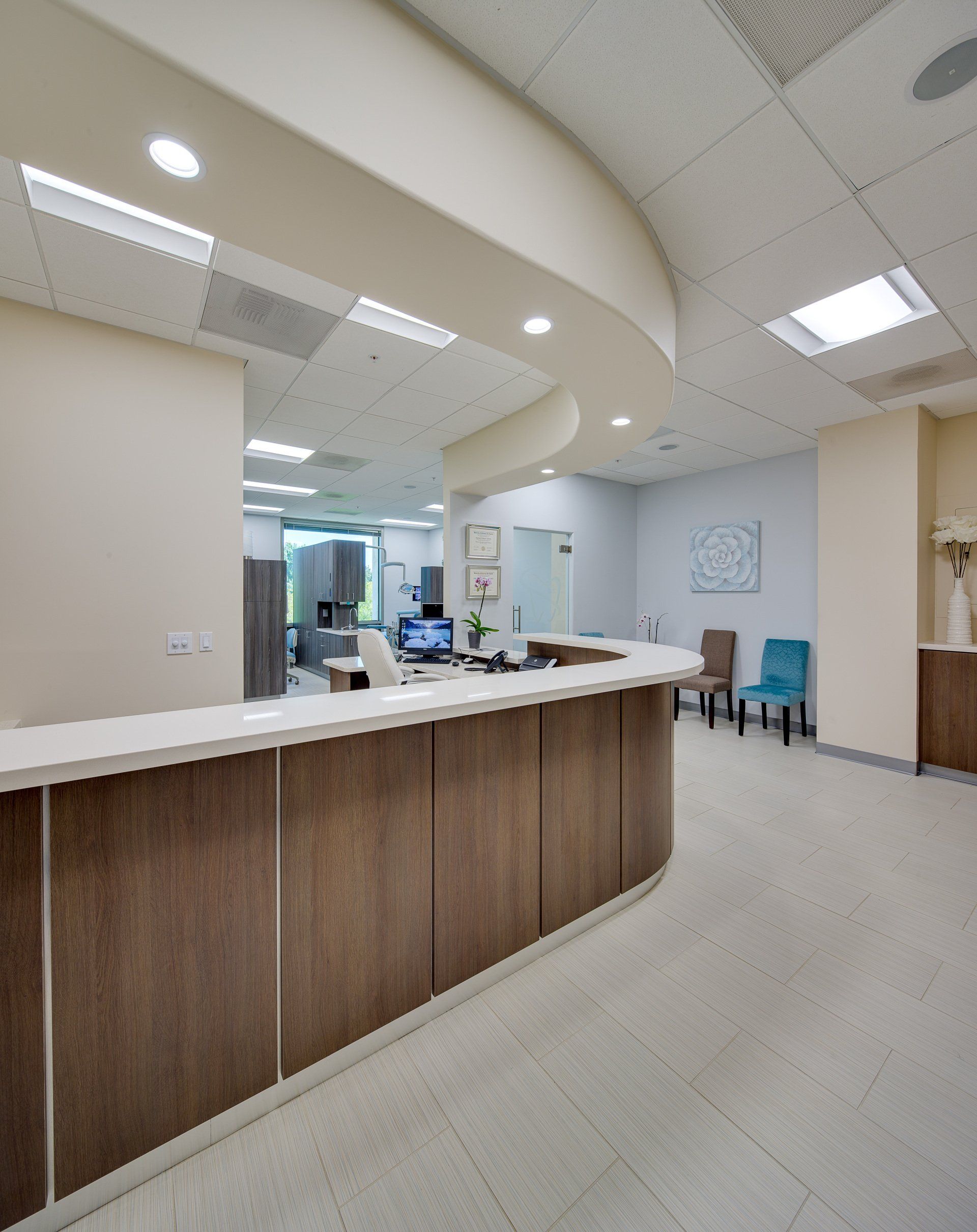 A hospital reception area with a long wooden counter