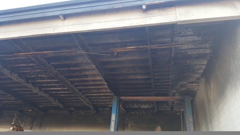 The ceiling of a building with a lot of wooden beams
